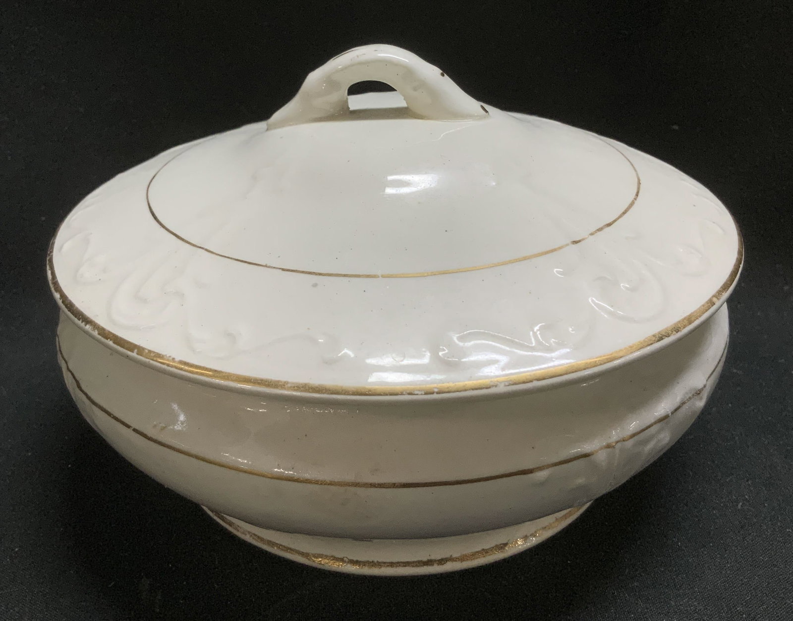 Sgnd Princess Embossed Ceramic Lidded Vessel: Antique lidded vessel features embossed scrollwork detailing & gilt accents. Signed & marked on underside. Reads, Princess. Rest of lettering is not legible. Surface wear consistent to age, use &