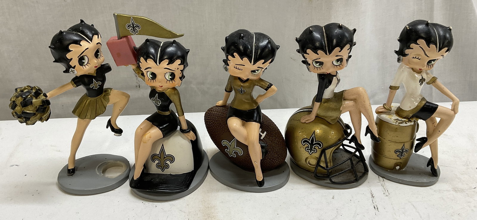 5 Hamilton Collec Belle of Saints Betty Boop Figs: 5 Hamilton Collection Belle of the Saints Betty Boop Figurines from 2014. Copyright The Hamilton Collection, King Features Syndicate Inc/Fleischer Studios Inc, TM Hearst Holdings Inc, and NFL