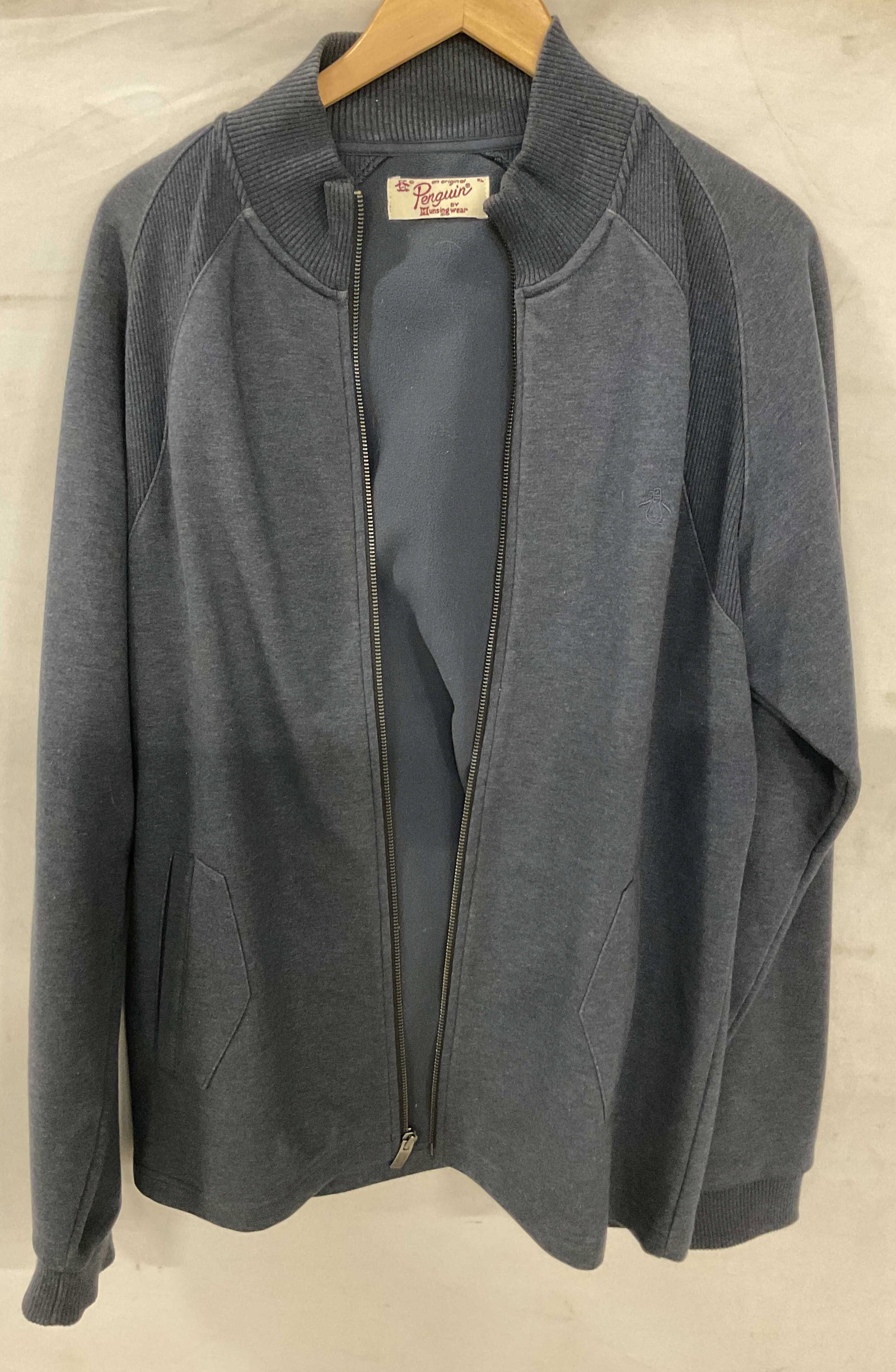 Penguin Munsingwear Blue Long Sleeve Zip Up: Penguin Munsingwear blue long sleeve zip up. Cotton material. Size XL. Tag reads An Original Penguin By Munsingwear. Ribbed trim. Zipper and front pockets. Embroidered logo. Surface wear consistent wi