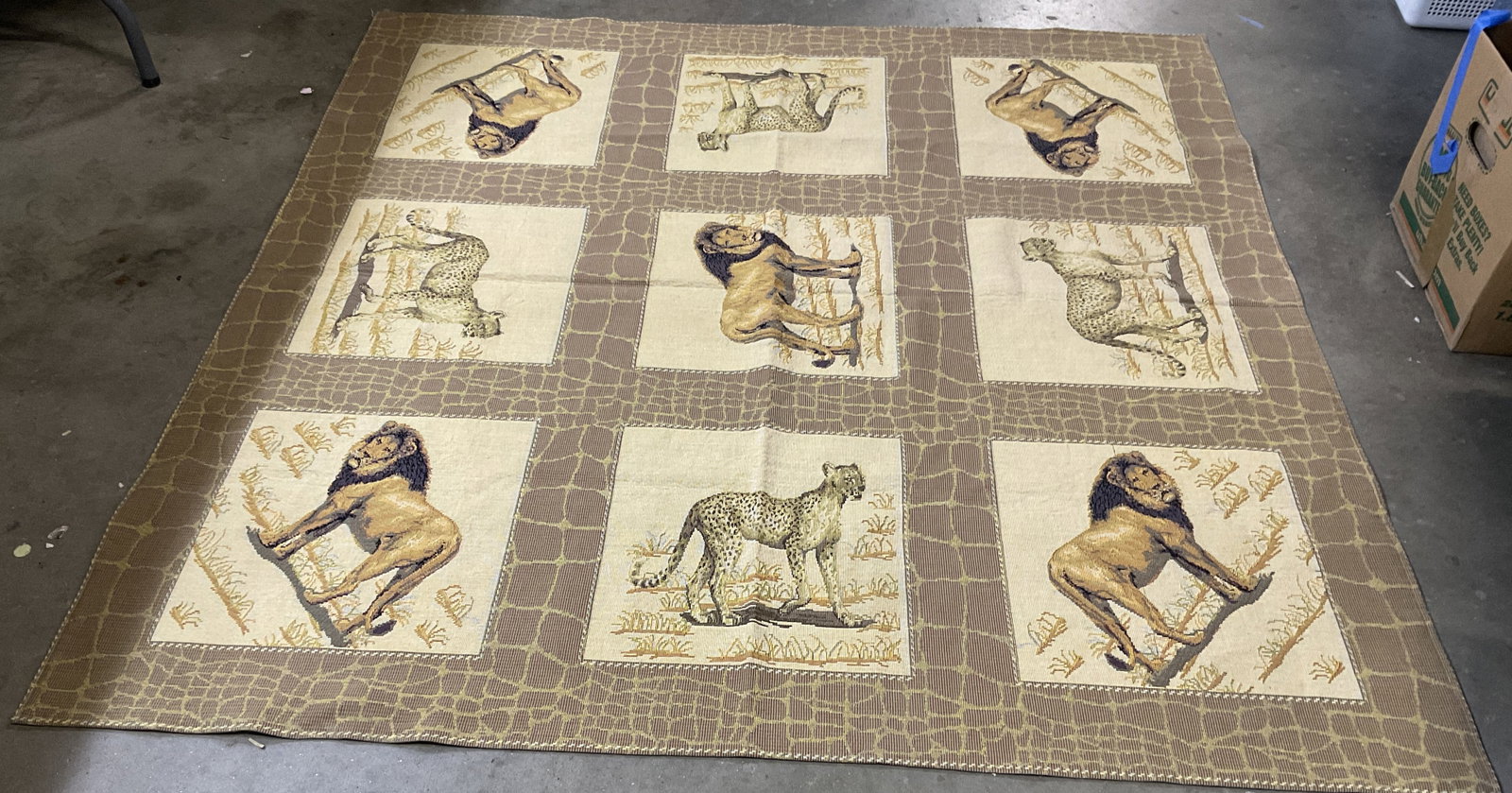 Goblys African Safari Tapestry Blanket FRANCE: Goblys African Safari Tapestry Blanket. Made in France. Features Lion and Cheetah Panels with a Giraffe Print Border. Beige, Brown, Amber, and Green with a Colorful Underside. Condition consistent wit