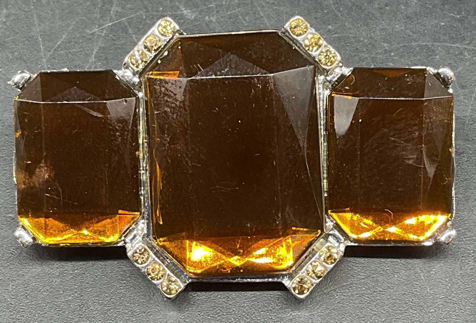 Vintage Silver Tone Orange Crystal Brooch: Vintage silver tone brooch with orange crystals. Measures approx. 1.25 x 1 7/8 inches. Some scratching. Jewelry, estate jewelry, costume jewelry, cocktail jewelry, fashion jewelry, accessories, fashio
