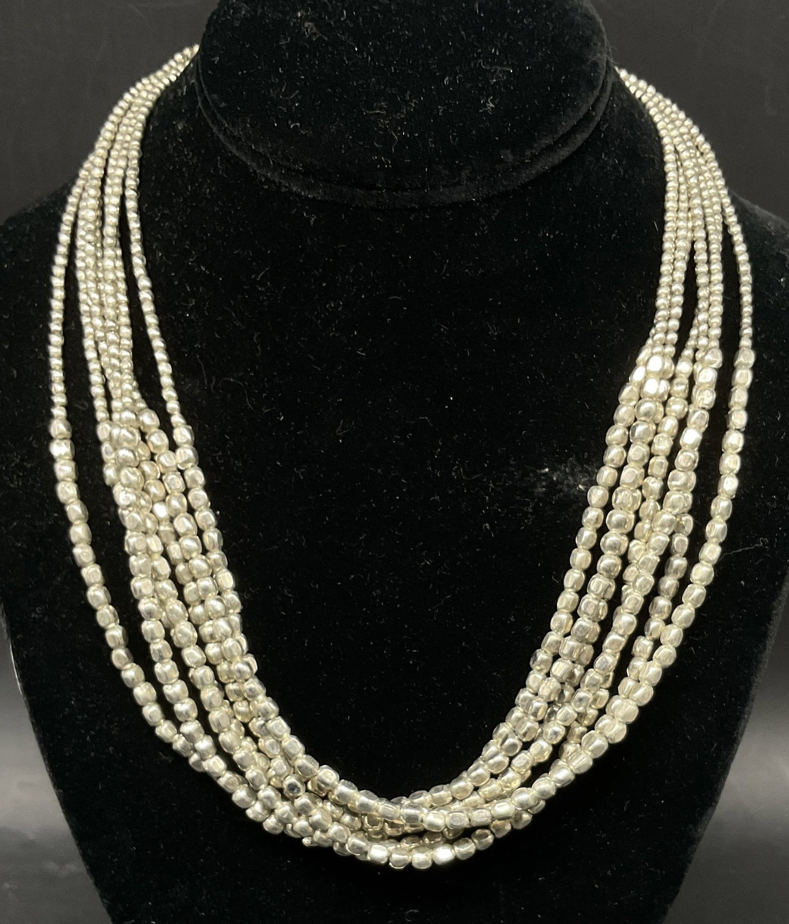 VTG Multi-Strand Silver-Toned Beaded Necklace: Vintage Multi-Strand Silver-Toned Beaded Necklace. Bib-Design. Small Beads that Flow into Large Beads. Adjustable. Measures app 8in Diam on Largest Setting. Multi-Strand, Silver-Toned, Beaded, Necklac