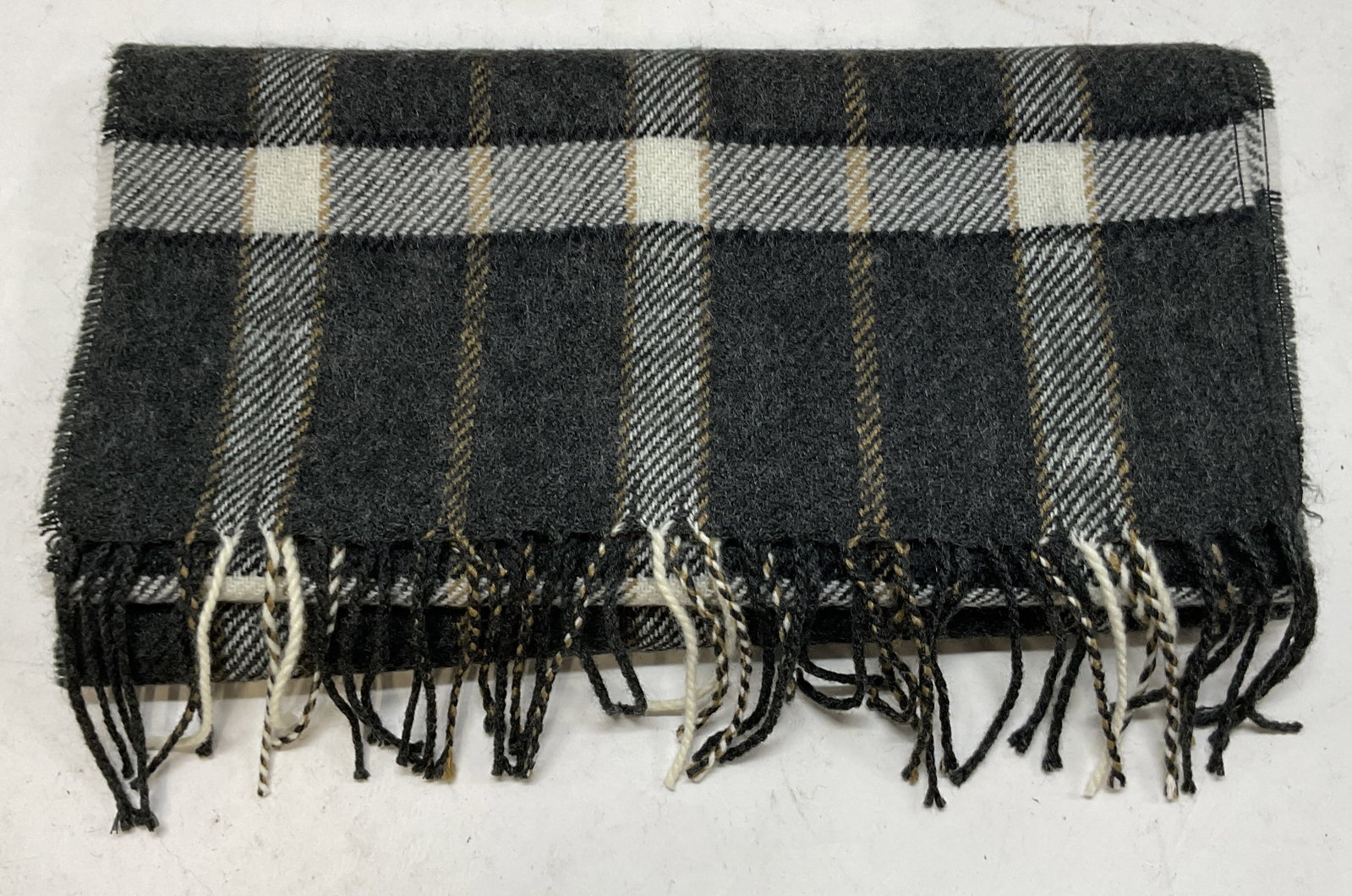 Vintage Black Plaid Fringed Scarf: Vintage black plaid fringed scarf. Fringed trim. Black, white, and cream plaid pattern. Measures approx 12.5 x 54 inches. Wear consistent with exposure. Scarf, wearables, clothing, outerwear,