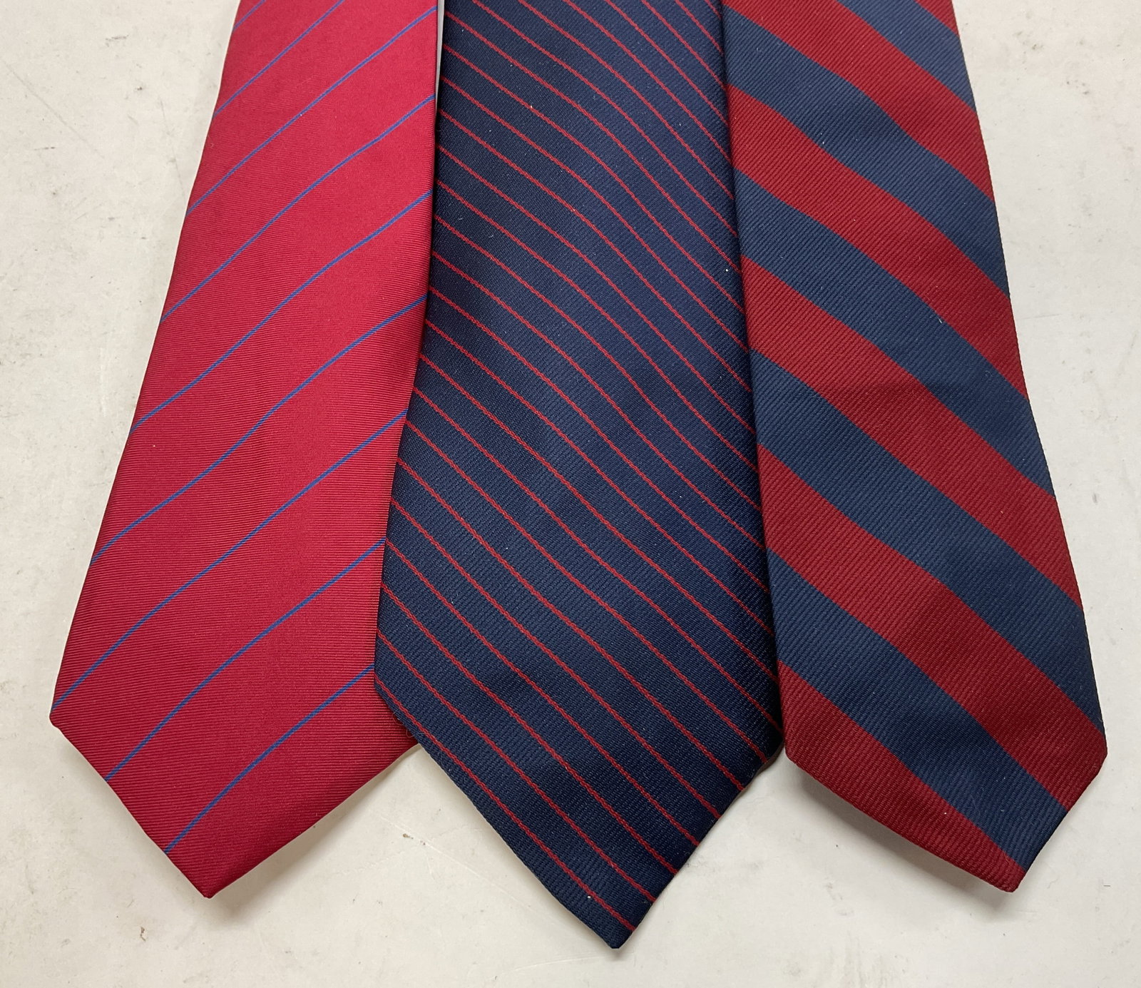 Lot 3 Assort Red & Blue Striped Silk Neck Ties USA: Lot of 3 assorted red and blue striped silk neck ties. Brands include 417 Van Heusen (USA). Two are unmarked. Red and blue striped pattern. Measures approx 3 x 54 inches (417 Van Heusen). Wear