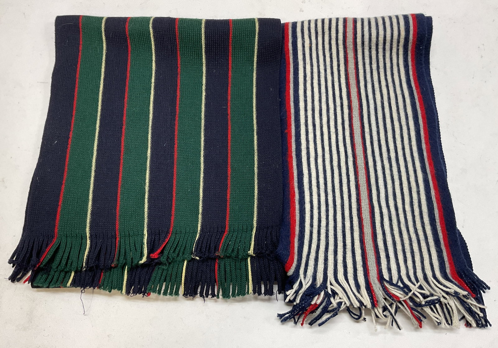 Lot 2 Vintage Wool Striped Fringed Scarves Germany: Lot of 2 vintage wool striped fringed scarves. One is marked All Lambswool Made In West Germany. Both are fringed and have striped patterns. Varying colors, blue white red, black green red. Measures a