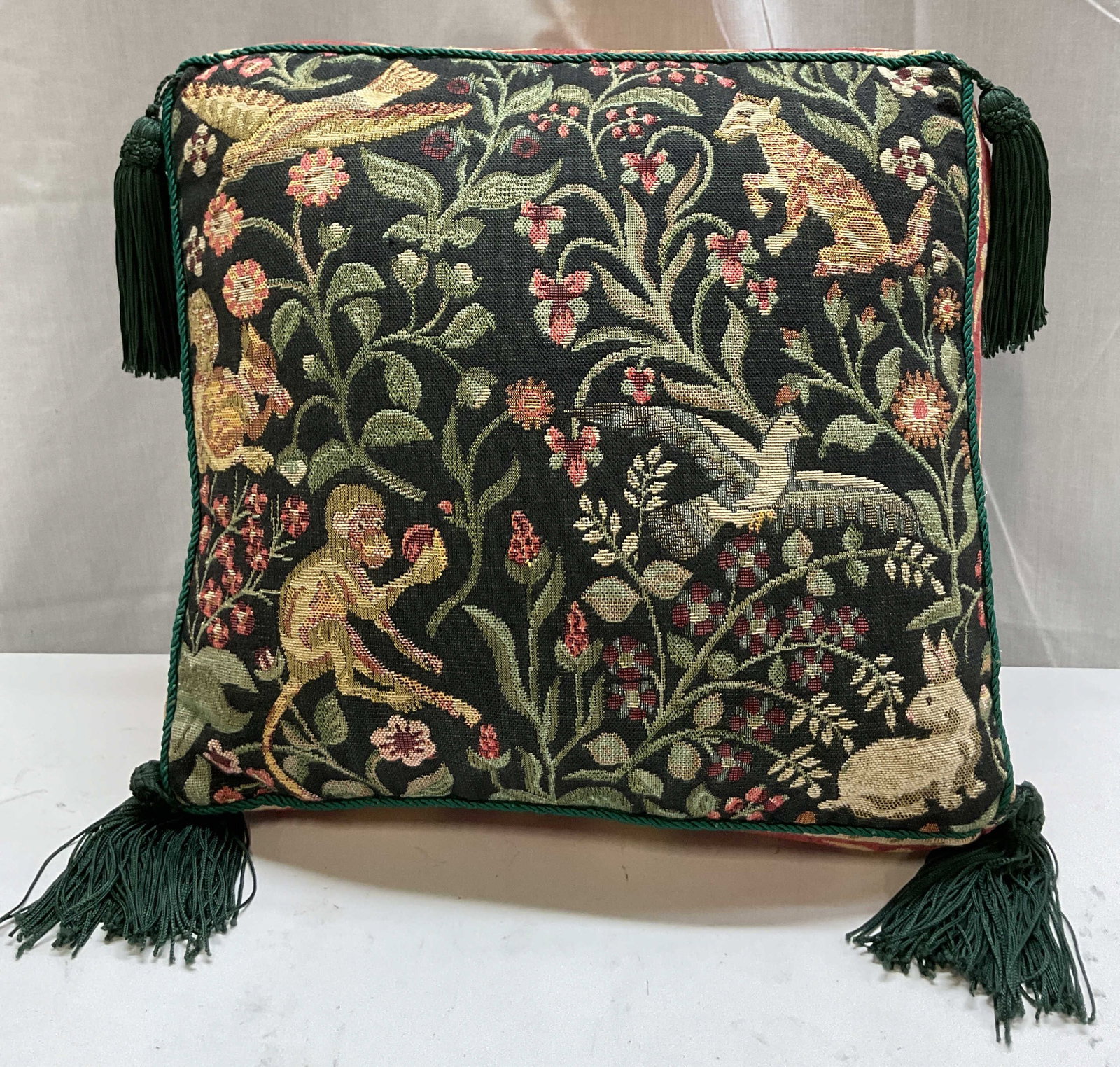 Tapisserie Tapestry Animal Throw Pillow USA: Tapisserie Tapestry Animal throw pillow. Made in USA. 100% cotton. Tag reads Tapisserie Tapestry Designs By Renaissance Woven Art New York. Green tassel corners with green braided rope trim. Animal mo