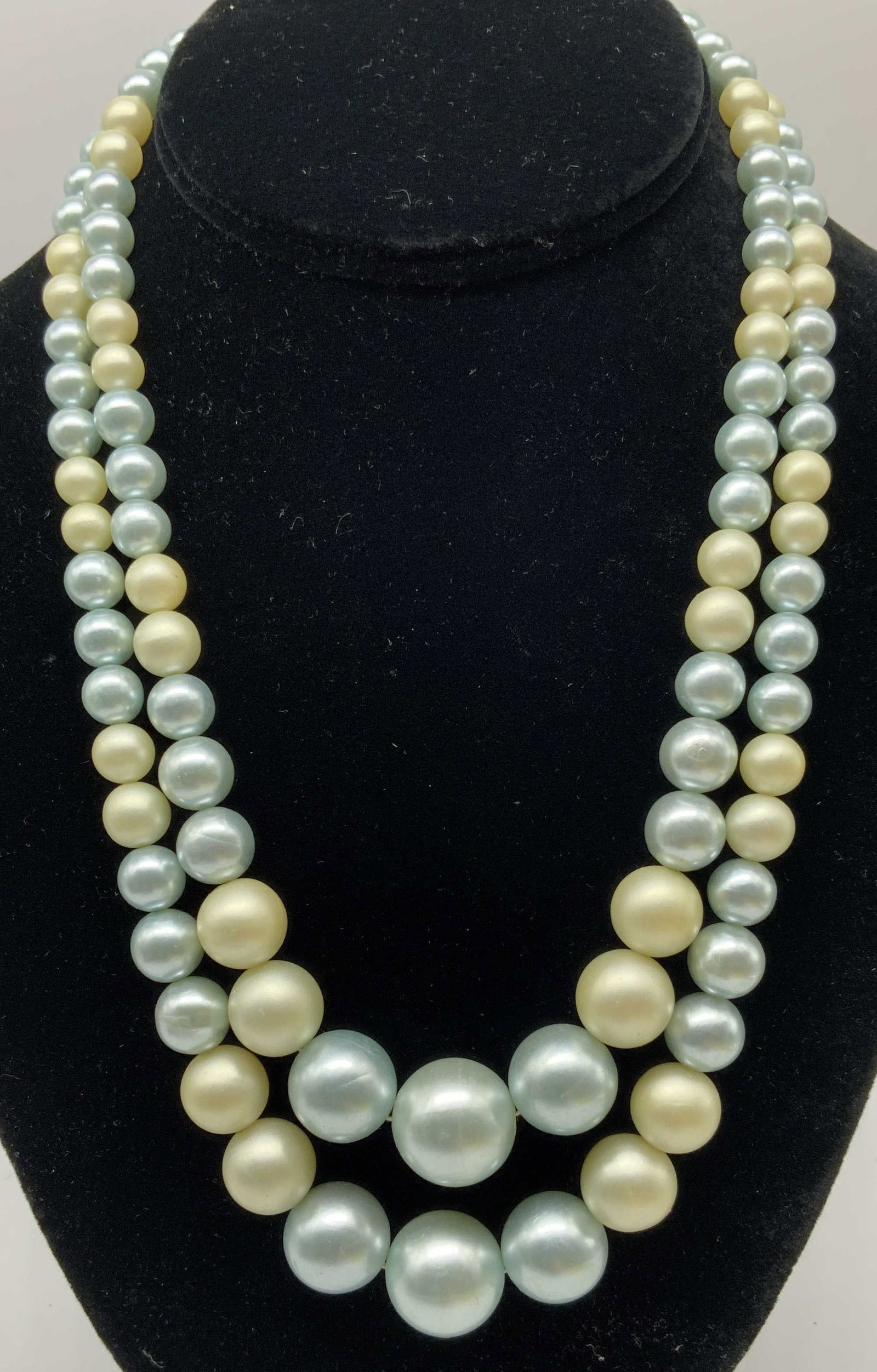 Vtg Double Strand Graduated Glass Pearl Necklace: Vintage Double Strand Glass Faux Pearl Necklace. Alternated coloration between cream yellow and pale blue. Beads scale upwards in size toward two large central focal glass pearls at the base of the dr