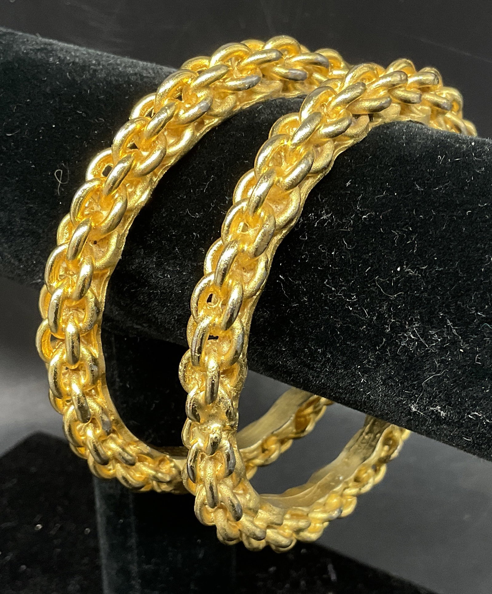 St2 VTG SGND 1961 Gold-Toned Chain Bangles: Set of 2 Vintage 1961 Signed Gold-Toned Bangles. Interlocking Chain Link Design. Signature Reads Illegibly. 1961 Etched Inside. Comes with Suede Storage Bag. Some Plating Loss. Measures app 3in Diam. 