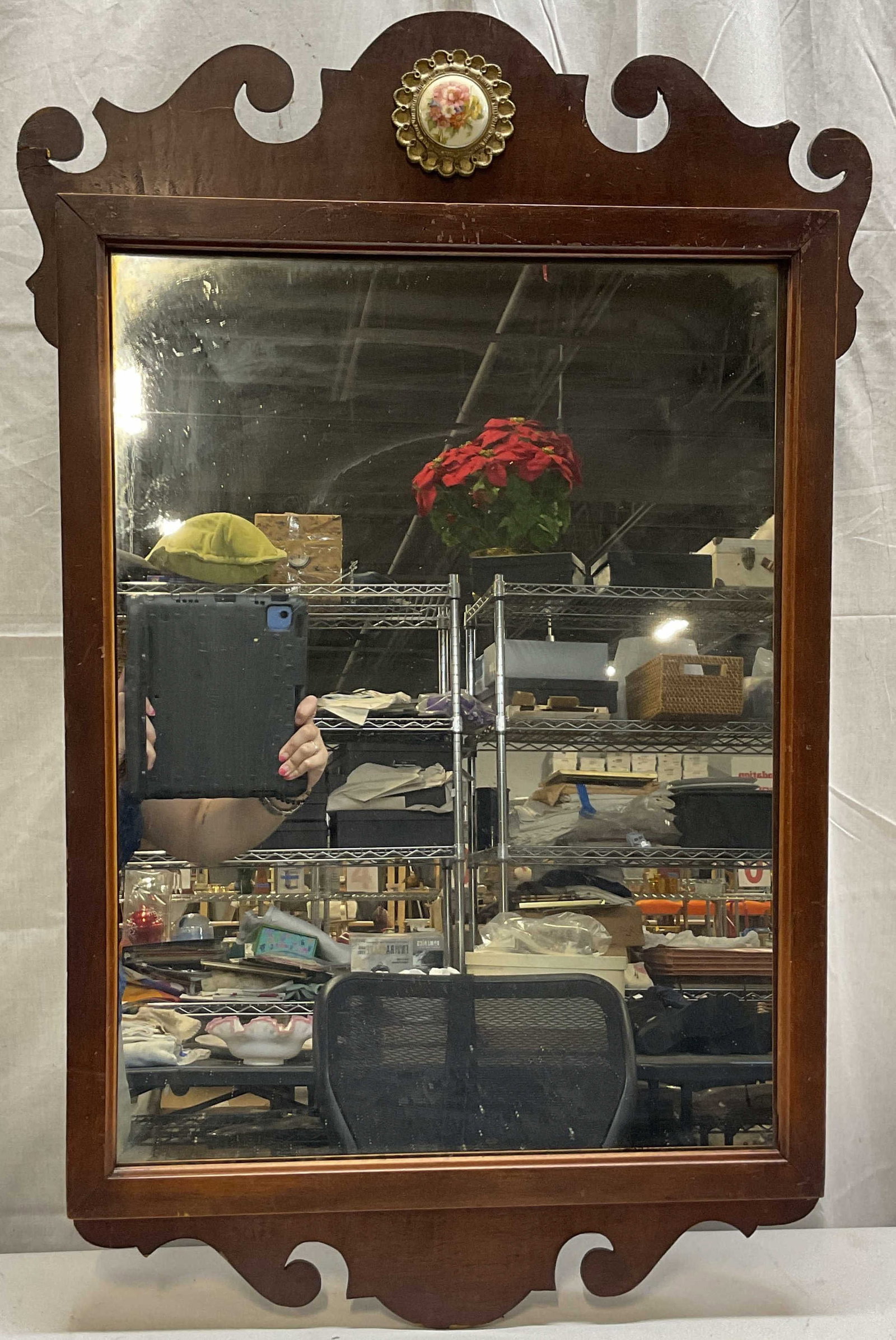 Vtg Chippendale Style Wooden Scroll Wall Mirror: Vintage Chippendale style wooden scroll wall mirror. Rectangular shape. Scrolled and scalloped accents. Porcelain and gold toned metal medallion on top. Scalloped edge. Floral motifs in varying