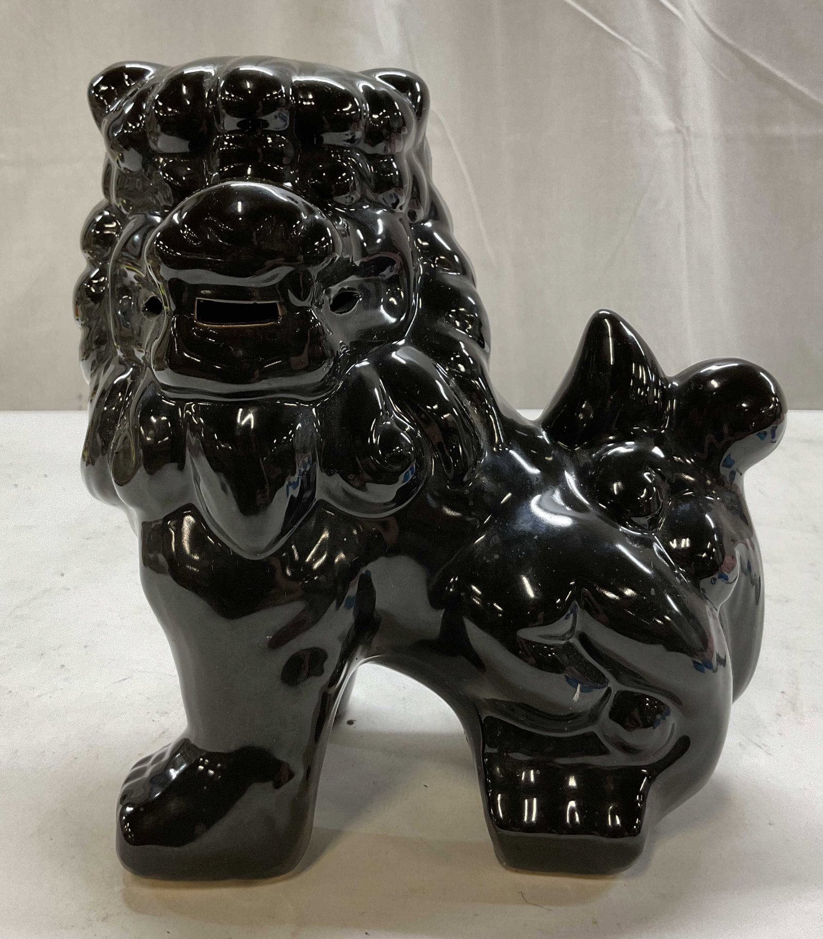 Vintage Black Ceramic Chinese Foo Dog Figure: Vintage black ceramic Chinese foo dog figure. Glossy finish, black glazed. Sitting Chinese foo dog figure. Intricate details and features. Measures approx 5 x 7 x 8 inches. Surface wear consistent