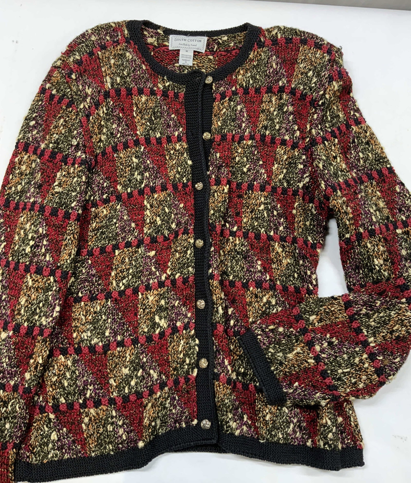 Vntg South Cotton hand knit cardigan: Vintage South Cotton hand knit cardigan. Made from a cotton viscose blend 100% hand knit in Bolivia. Size Medium. features gold toned metallic buttons, shoulder pads, and ribbed black collar, hem and