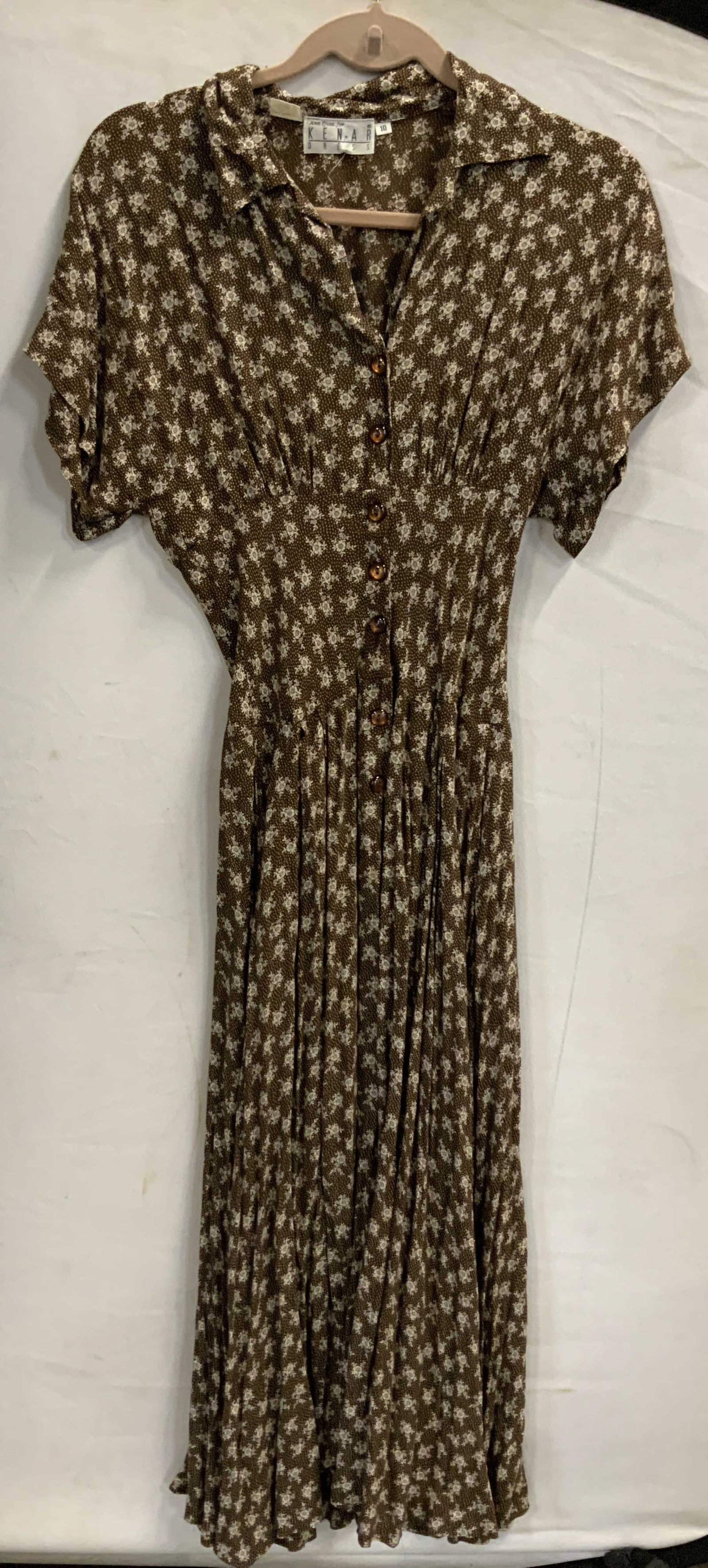 Vntg Kenar ditsy floral brown midi dress 1990s: Vintage Kenar ditsy floral brown midi dress. From the 1990s made of 100% rayon. Size 10. Features a ditsy floral print, a pattern made of tiny densely packed flowers. This color way uses chocolate bro