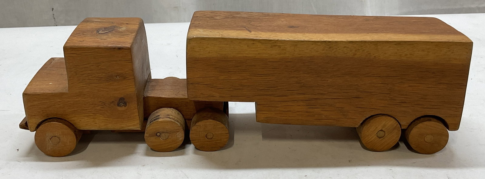 Vintage Hand Made Wooden Semi Truck: Vintage hand made wooden semi truck. Inscribed on underside as photographed here. Adjustable movements. Features 10 wheels and trailer. Measures approx 3 x 14 x 3.5 inches. Scratching. Wooden semi