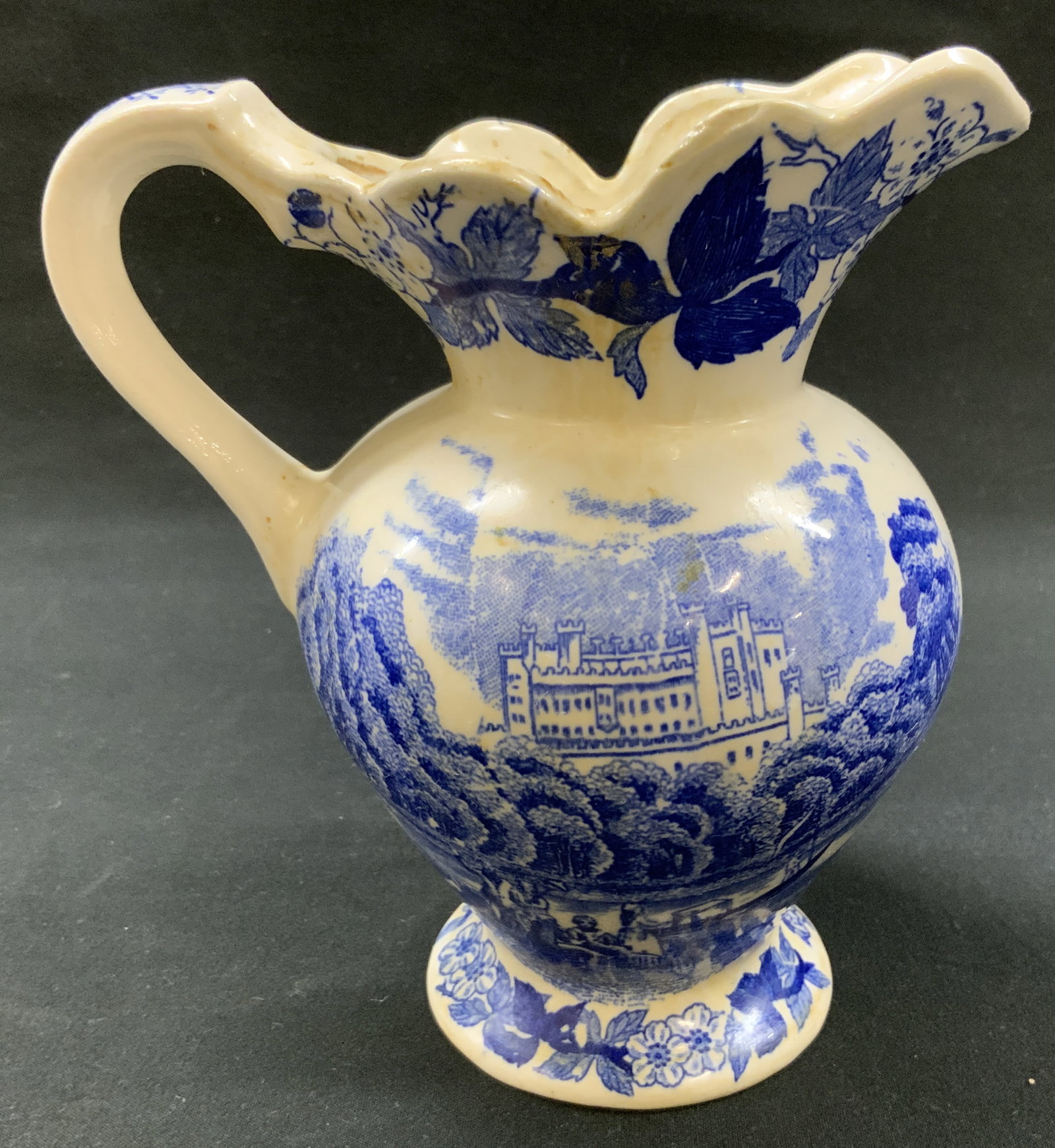 Vtg English Blue Transferware Pitcher: Vintage English Blue Transferware Pitcher. Detailed landscape scene depicting castle nestled behind hills and trees. No markings. Measures approx. 6 x 6 x 3 inches Condition consistent with age and ex