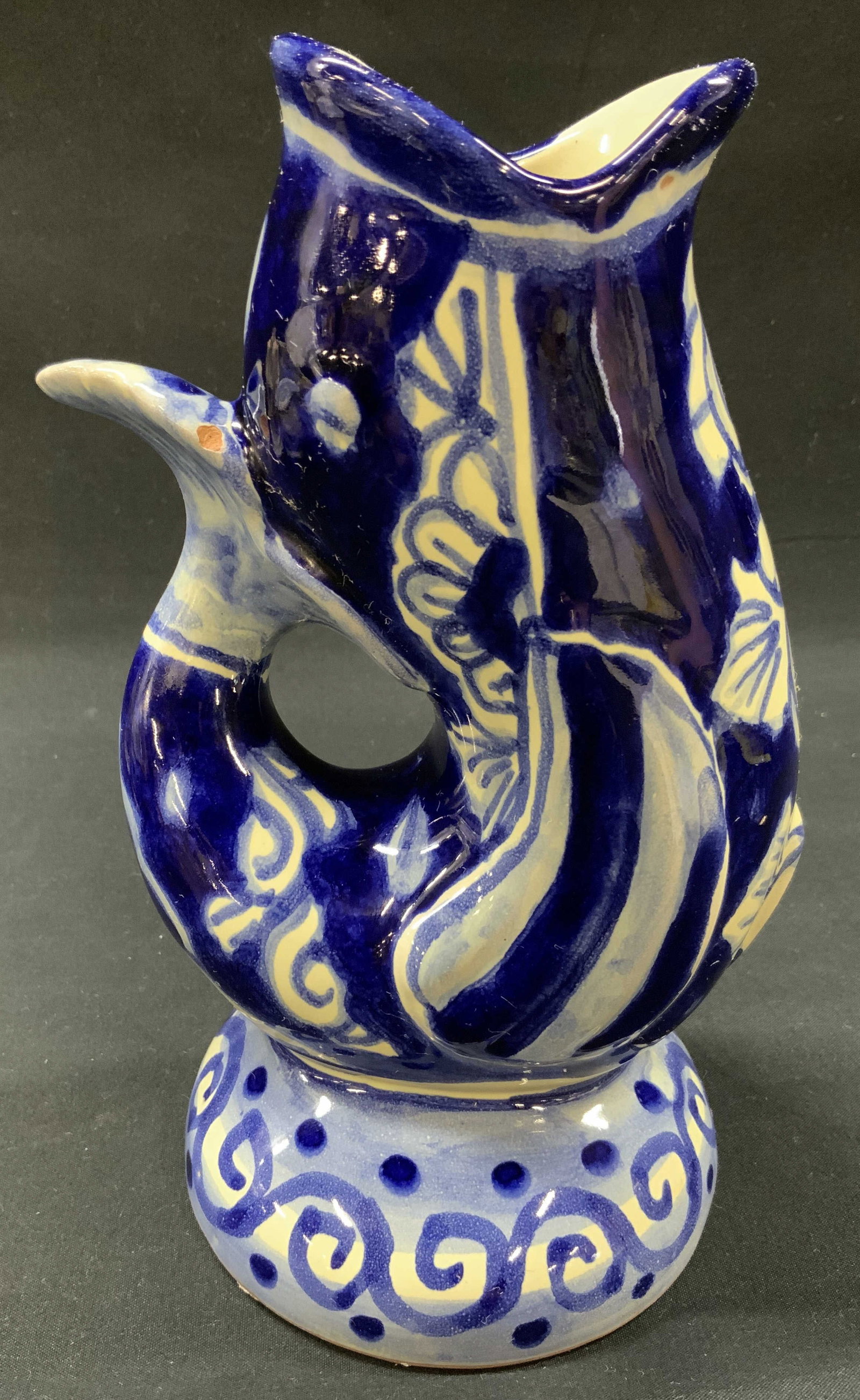 Vtg Talavera Style Blue Fish Pitcher, Mexico: Vintage Talavera Style Blue Fish Gurgle Pitcher, Made in Mexico. Fashioned in the shape of a stylized fish. Deep cobalt and cream tin glaze palette. Hand painted. Underside reads HECHO EN MEXICO