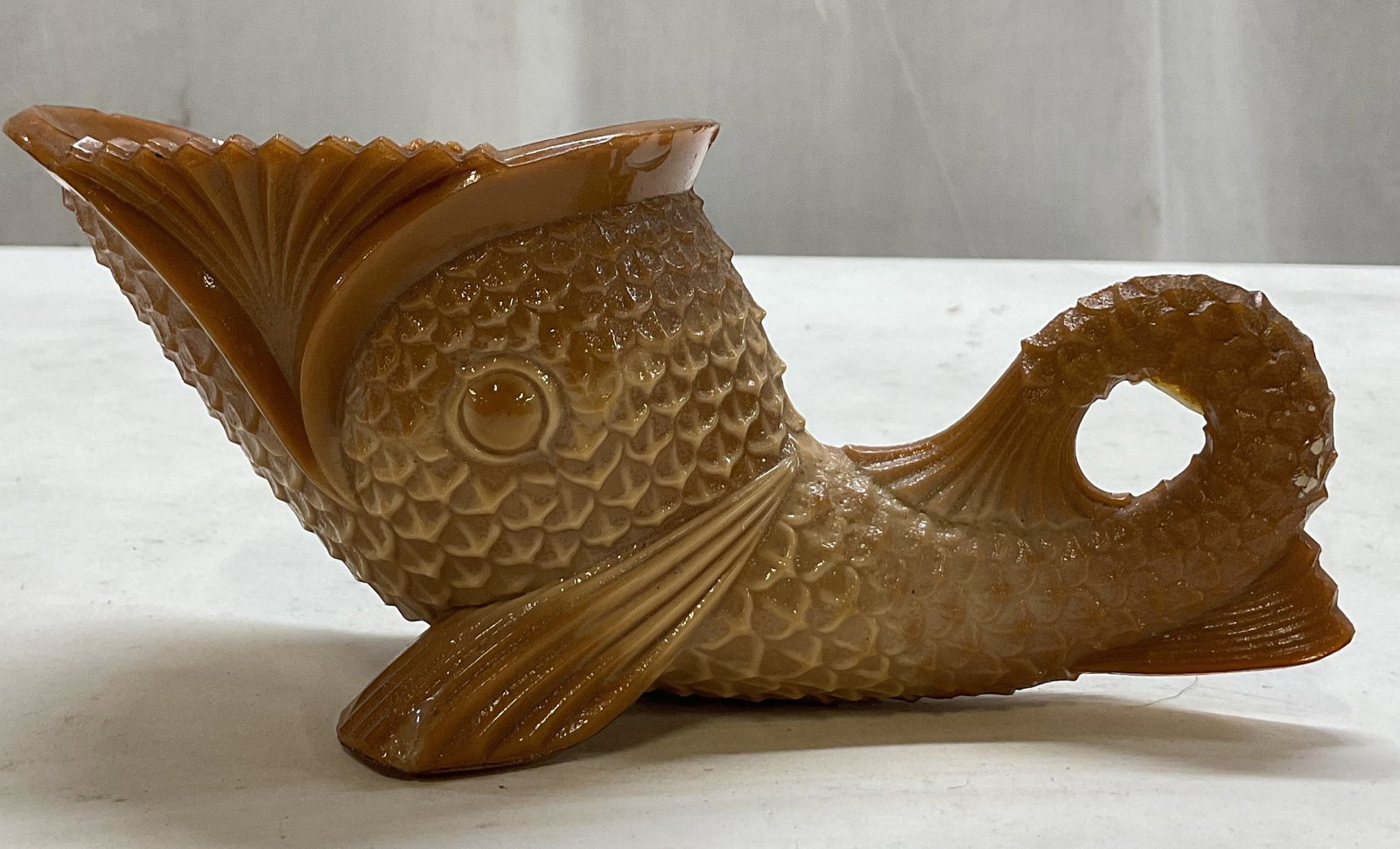 Antq Greentown Glass Chocolate Slag Fish Dish: Antique Greentown Glass chocolate slag fish dish. Possibly a dolphin figure. Wide mouth, dish opening. Detailed scale texture. Chocolate brown color. Sawtooth rim. Measures approx 3.5 x 7 x 3.5