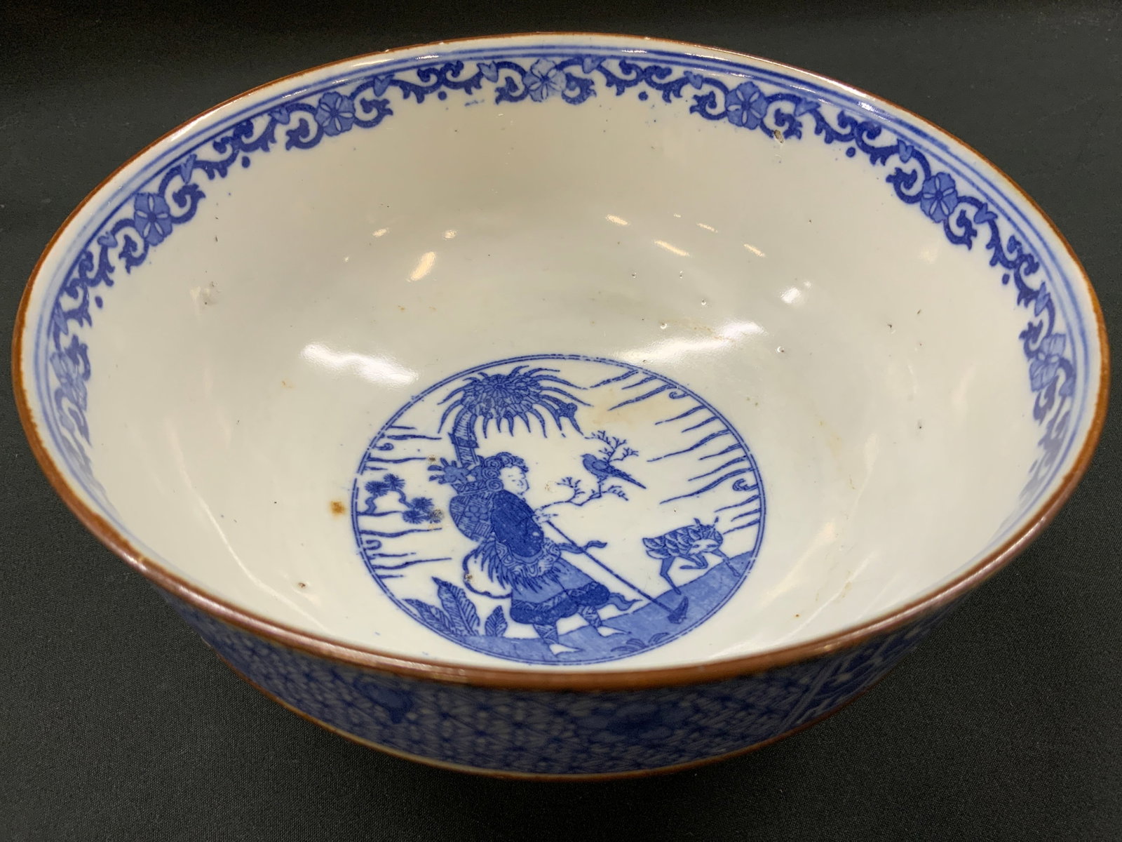 Vtg Japanese Arista Blue & White Porcelain Bowl: Vintage porcelain bowl with blue and white underglaze decorations. Interior center medallion depicts figure standing beneath palm tree with bird on branch. Rim decorated with continuous border.