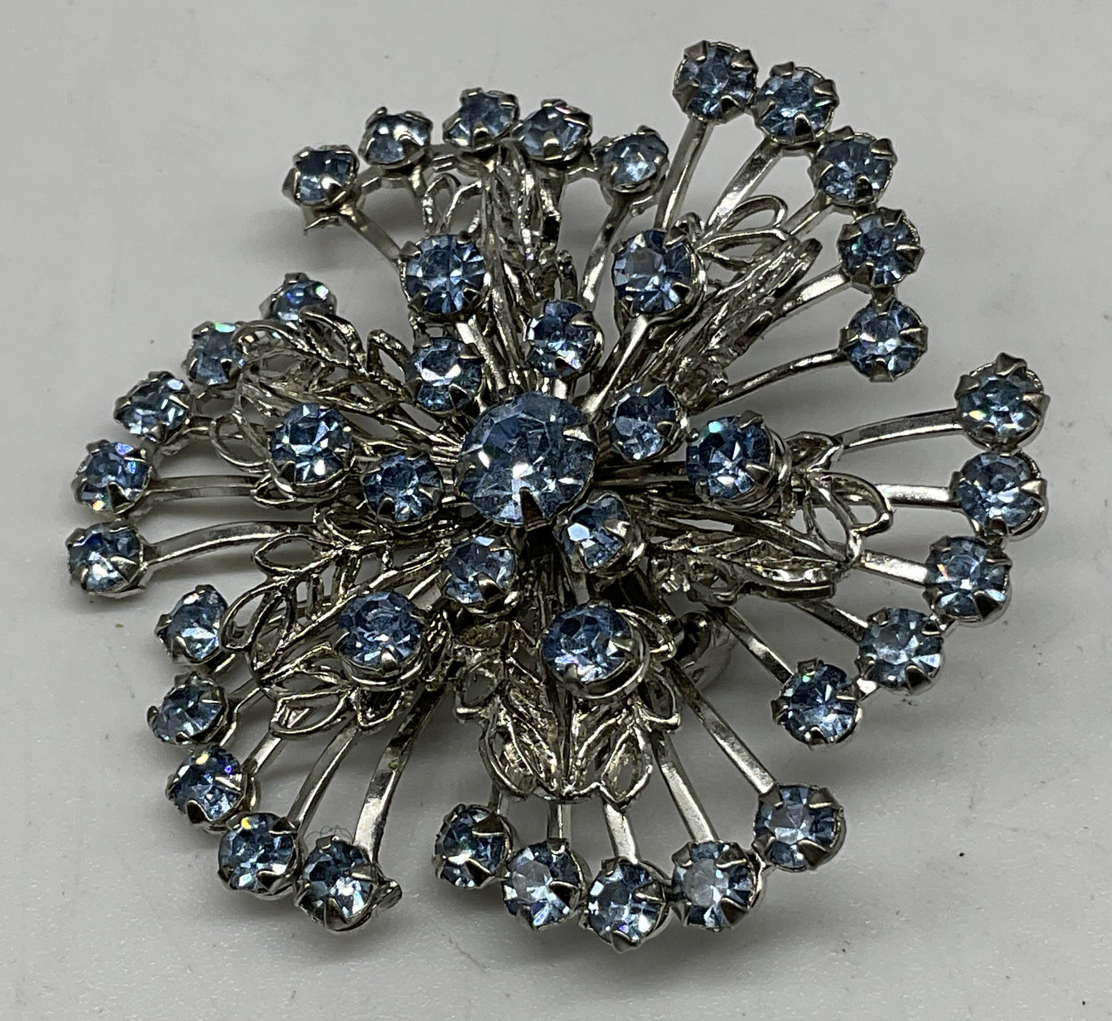 VTG Multi-Tiered Rhinestone Snowflake Brooch: Vintage Circa 1950s-1960s Multi-Tiered Ice Blue Rhinestone Silver-Toned Snowflake Brooch. Plating loss present. Measures approx 1.75in Diam. vintage jewelry, rhinestones, snowflake, silver-toned, broo
