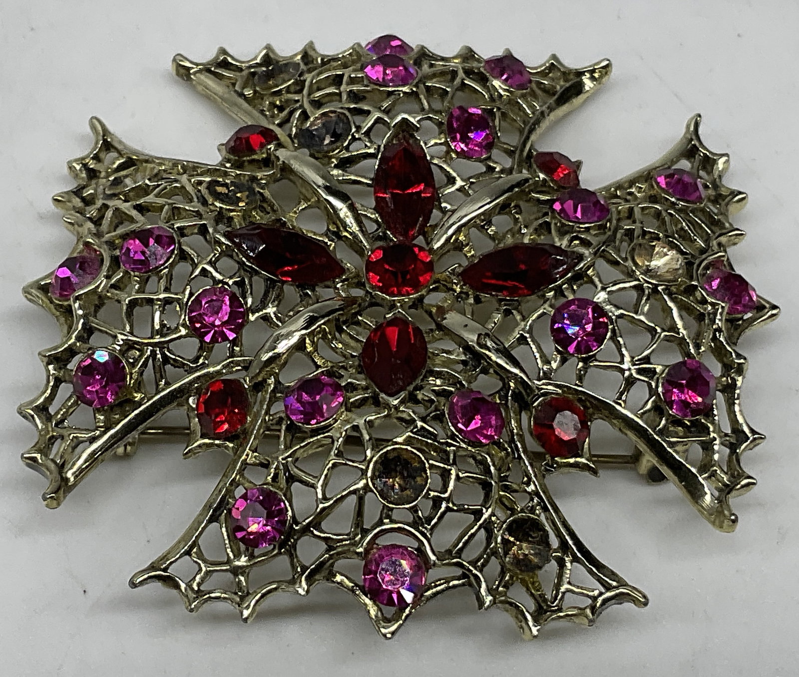 VTG Maltese Cross Filigree Rhinestone Brooch: Vintage Maltese Cross Silver-Toned Filigree Rhinestone Brooch. Red and pink stones. Missing stones. Some color loss. Measures app 2in Diam. rhinestones, silver-toned, brooches, pins, costume jewelry 8