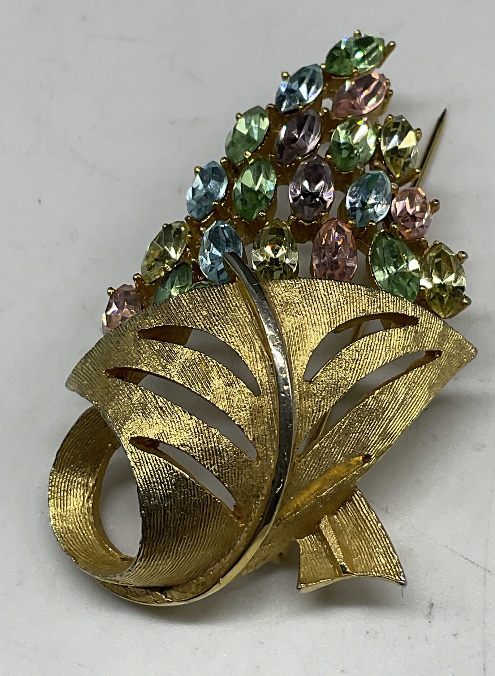VTG Pastel Cornucopia Floral Bouquet Brooch: Vintage Pastel Rhinestone Cornucopia Floral Bouquet Brooch. Gold-Toned. Condition consistent with exposure. Measures app 2.5in H x 1.25in W. rhinestones, pastel, spring, easter, gold-toned, brooches,