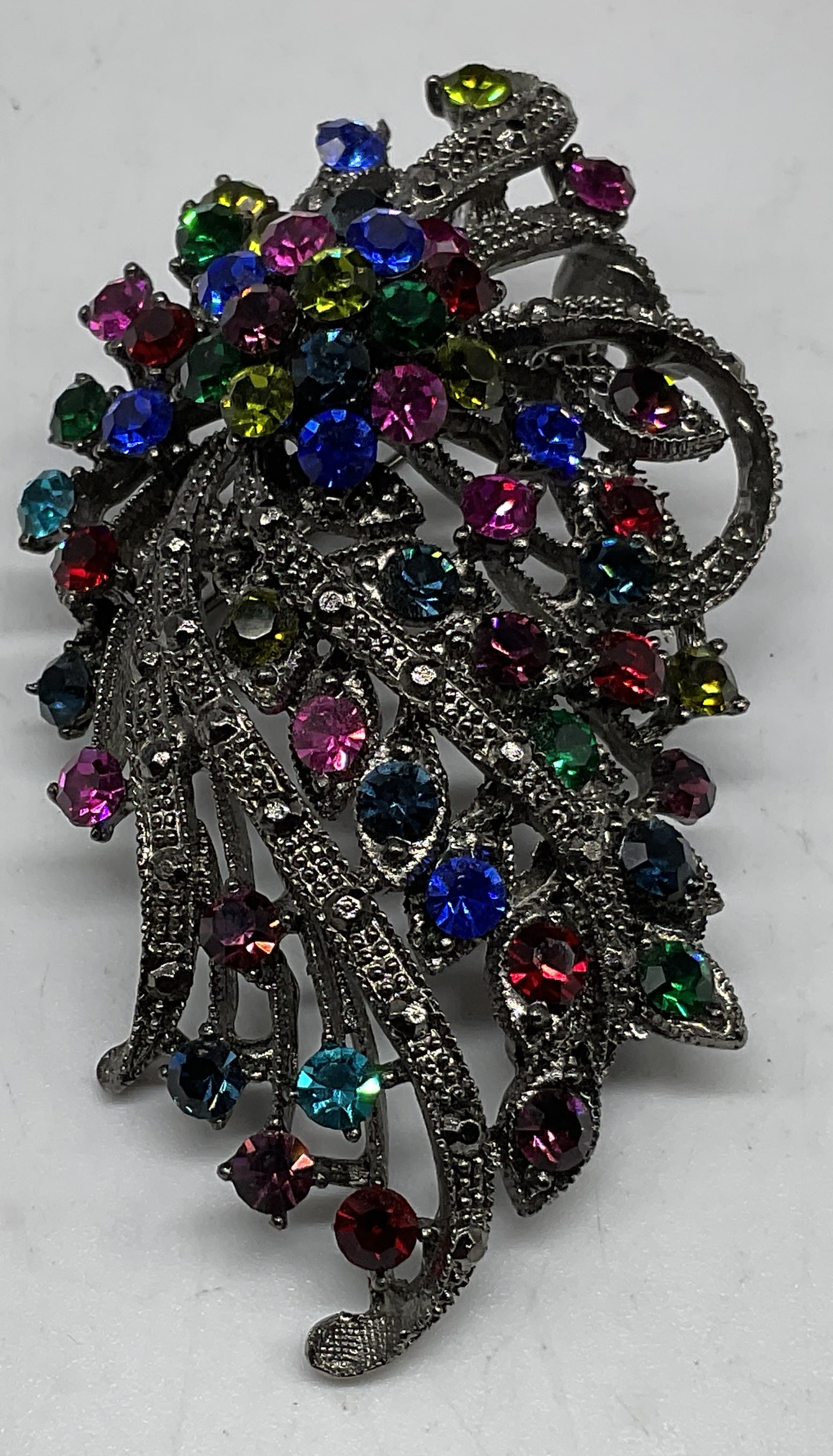 VTG-Style Rainbow Rhinestone Floral Cascade Brooch: Vintage-Style Rainbow Rhinestone Floral Cascade Brooch. Silver-Toned. Condition consistent with age and exposure. Measures app 3in H x 1.5in W. rhinestones, silver-toned, brooches, pins, fashion acces