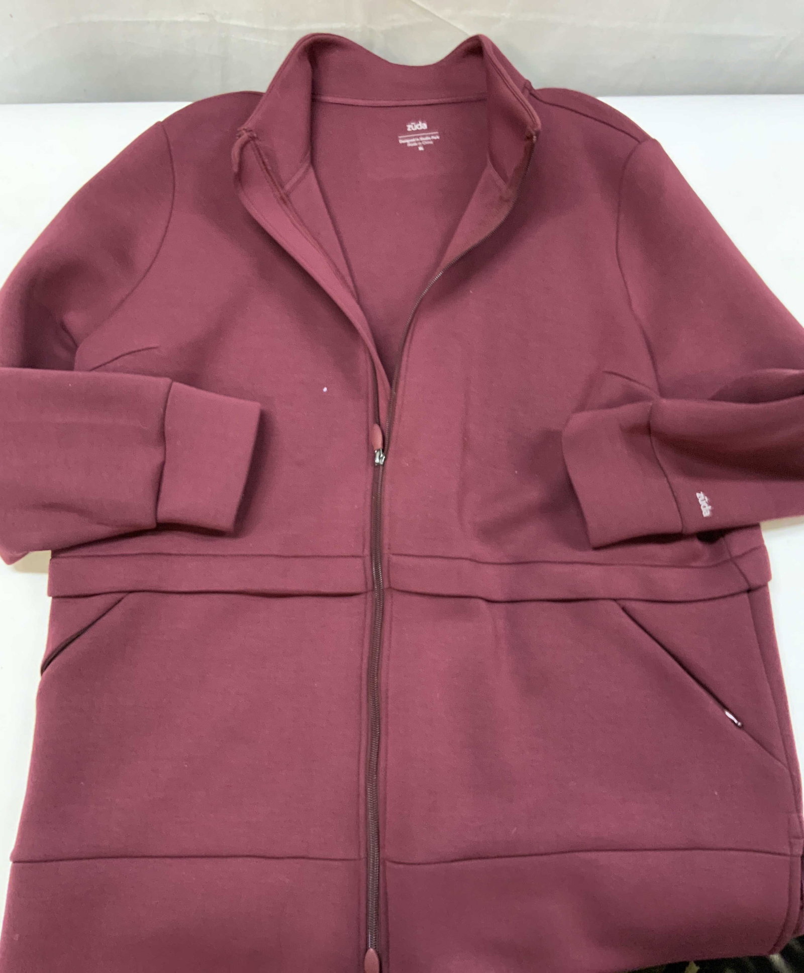 Zuda belted scuba zip front jacket: Zuda belted scuba zip front jacket. Designed in Studio Park size XL. Crafted from a signature smooth ,tech knit fabric. Equipped with a clean tagless mock neck that hold shape weather fully or partial