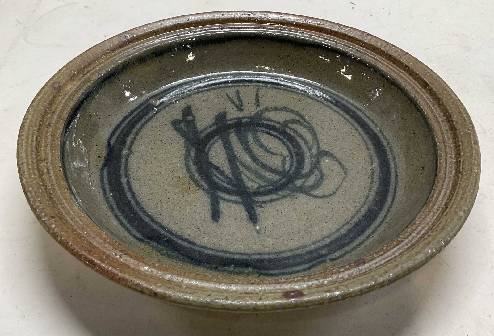 Vintage Glazed Ceramic Pottery Bowl: Vintage glazed ceramic pottery bowl. Signed on underside, reads illegible. Wide rim. Dark toned glaze, glossy finish. Abstract design. Underside is unglazed. Measures ht approx 2 inches diam approx