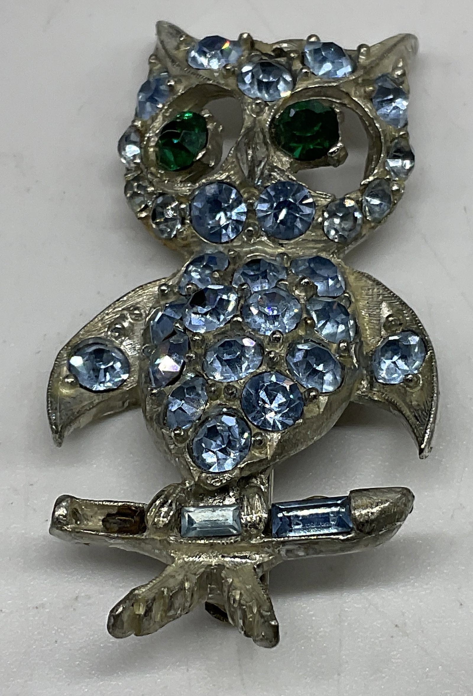 VTG 1960s Pell Rhinestone Owl Brooch: Vintage 1960s Pell Owl Brooch. Silver-toned with blue and green rhinestone accents. Missing stones. Measures approx 2in H x 1in L. vintage, Pell, 1960s, rhinestones, owl, silver-toned, brooches,