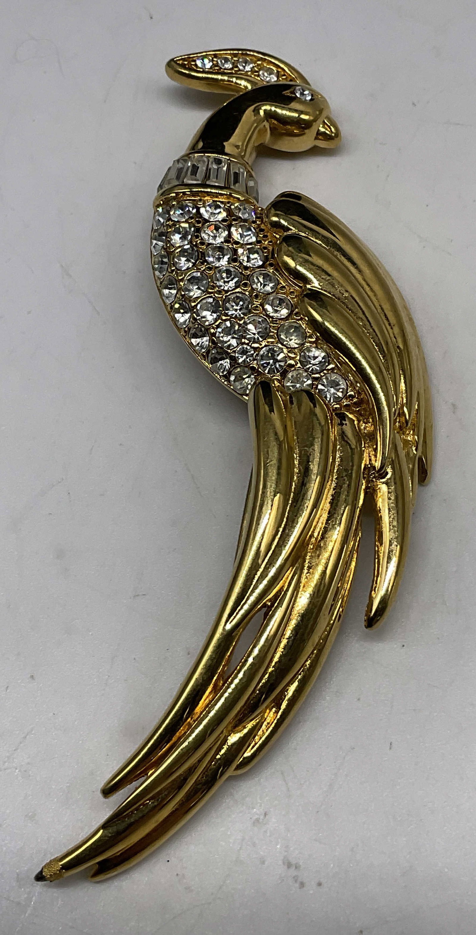 VTG 1980s Monet Bird of Paradise Brooch: Vintage 1980s Monet Bird of Paradise Brooch. Gold-Toned with white rhinestone accents. Condition consistent with age and exposure. Measures approx 4in H x 1in W. vintage, 1980s, Monet, birds,
