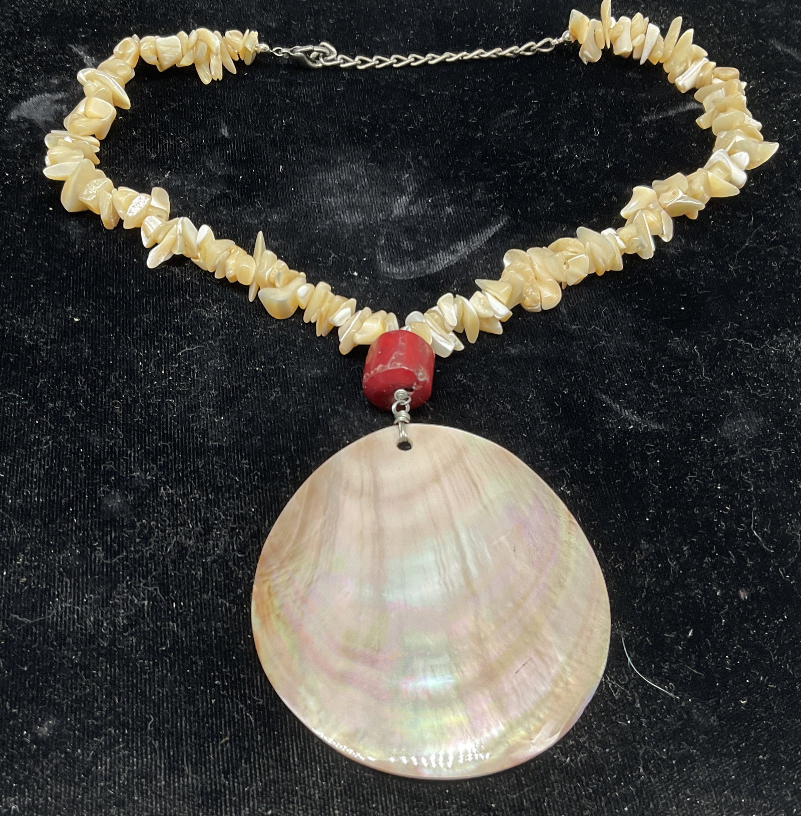 VTG Mother-Of-Pearl Disc Pendant Necklace: Vintage Necklace. Pink Mother-Of-Pearl Disc Pendant. Irregular mother-of-pearl chips. Cylindrical red semi-precious gemstone accent. Tested with Presidium Gem Tester II. Condition consistent with age 