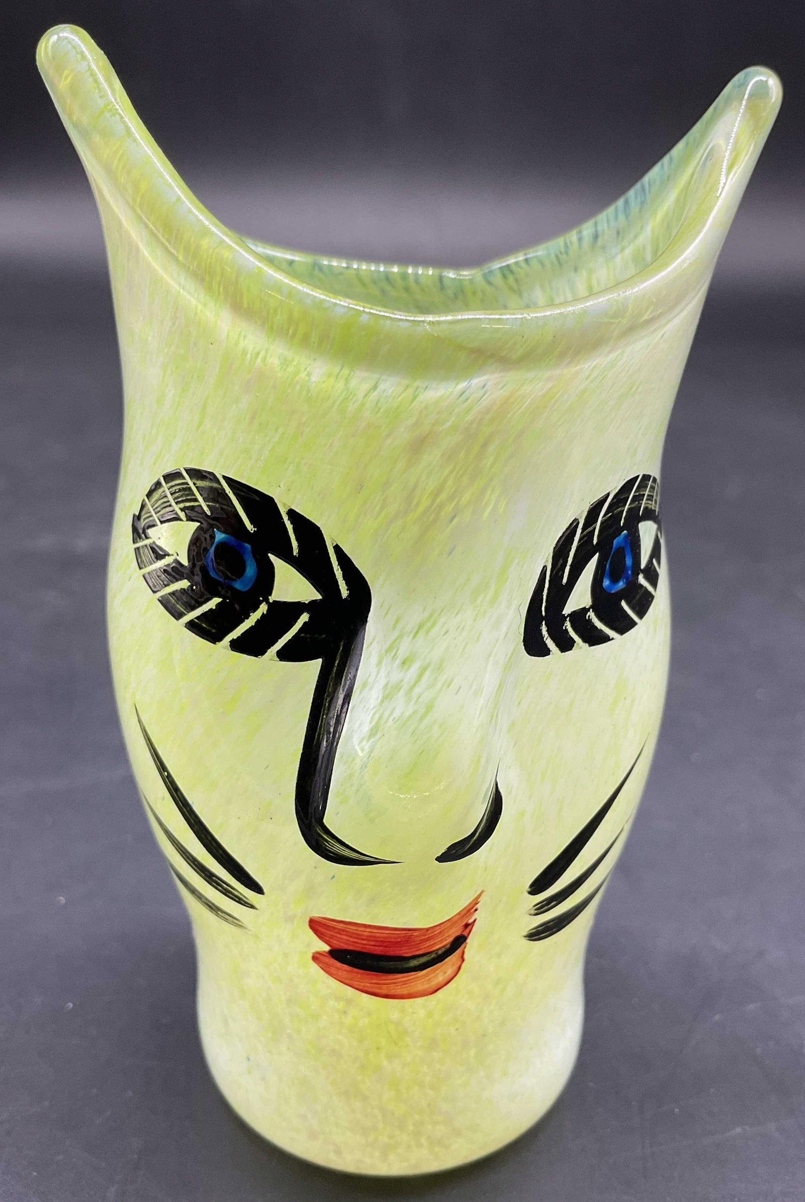 Kosta Boda Open Minds Face Vase: A miniature open minds art glass face vase in yellow green, designed and hand painted by Ulrica Hydman-Vallien for Kosta Boda Sweden, measures ht app 4 inches, smalls, signed
