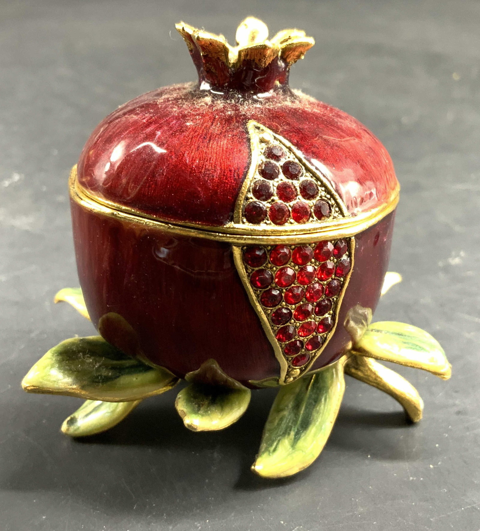 Hand Crafted Pomegranate Quest Trinket Box: Hand crafted Pomegranate Lidded Trinket box signed by Quest Collection, features a rich hand painted maroon enamel , detailed to look like a split pomegranate on leaf shaped feet, finish, 24 k gold pl