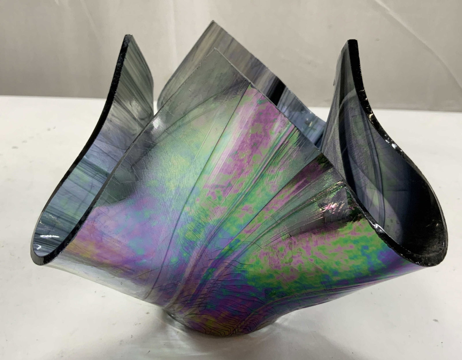 Tony Serviente Iridescent Handkerchief Vase: Tony Serviente ( Unsigned) art glass iridescent Blown glass Folded Handkerchief Vase, featuring an organic dramatic ruffled draped form with a shimmering rainbow sheen, measures ht app 5 inches,