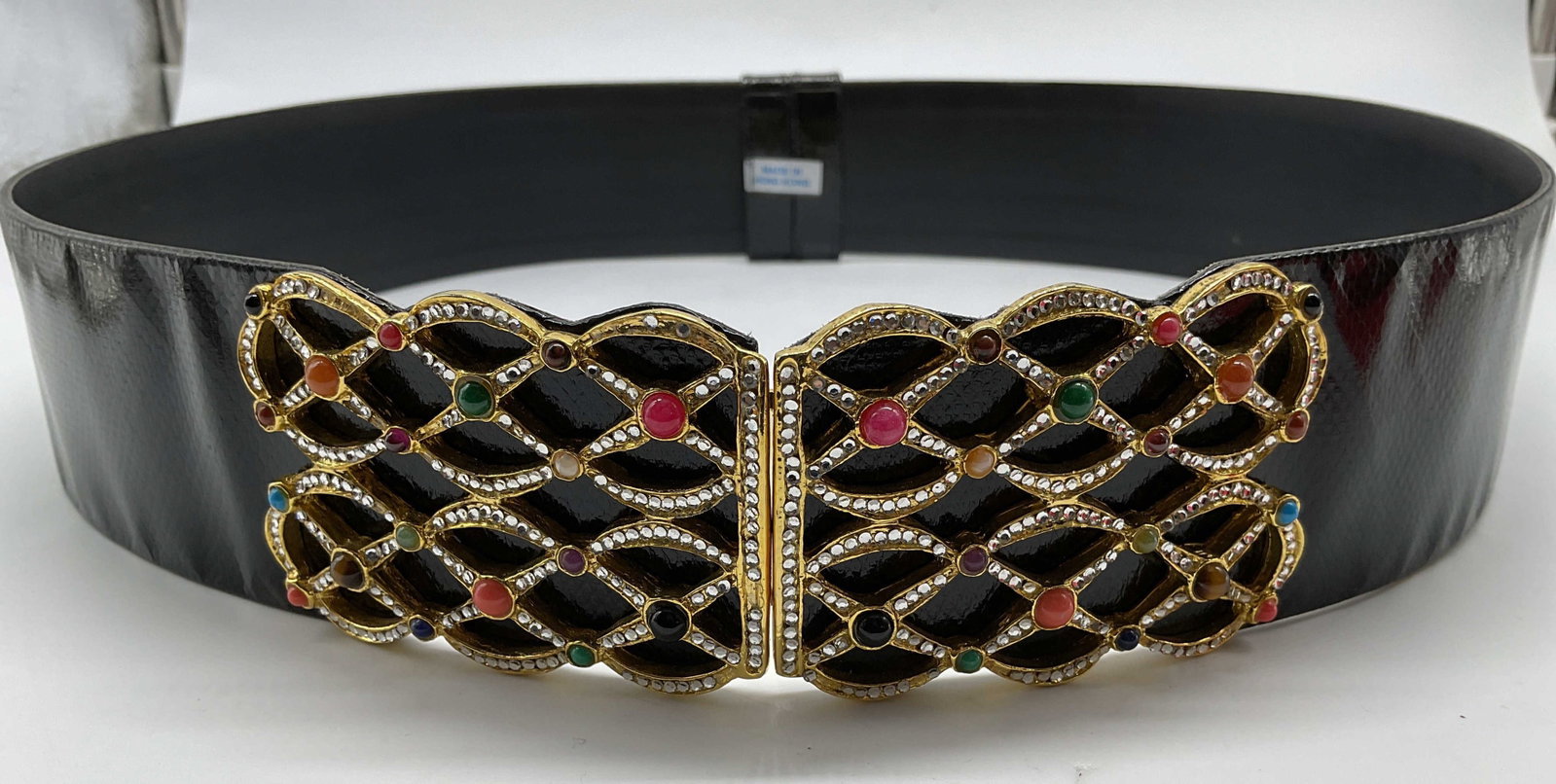Vntg Ashneil Black Leather Belt ornate buckle Sgn: Signed Vintage Ashneil Black Patent Leather Statement Belt features an ornate interlocking gold tone filigree buckle encrusted with clear rhinestones and colorful cabochon accent stones, densely set