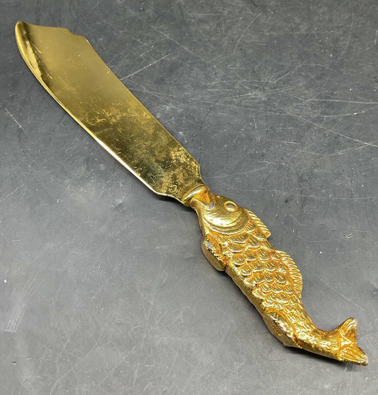 Gold Tone Brass Fish Shaped Serving Knife: Vintage gold toned brass textured Koi Fish handled fish knife serving piece, measures length app 9 inches, has flat feet for standing , smalls