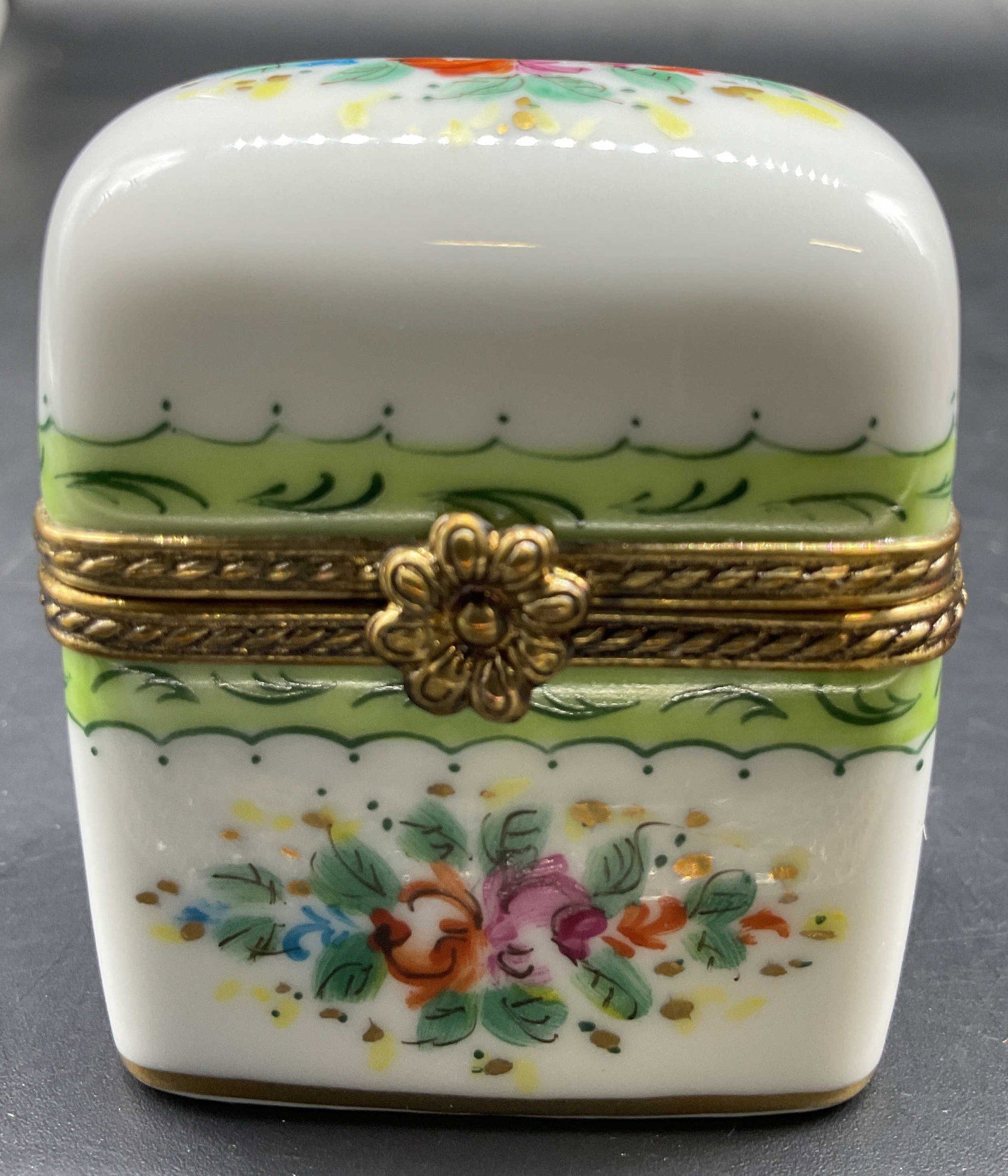 ROCHARD Limoges Porcelain Pill Box, France: Rectangular hinged lidded pill box, white w lime green trim and florals, signed ROCHARD, Limoges France, hand painted, measures app 2 inches by 1.75 inches, smalls