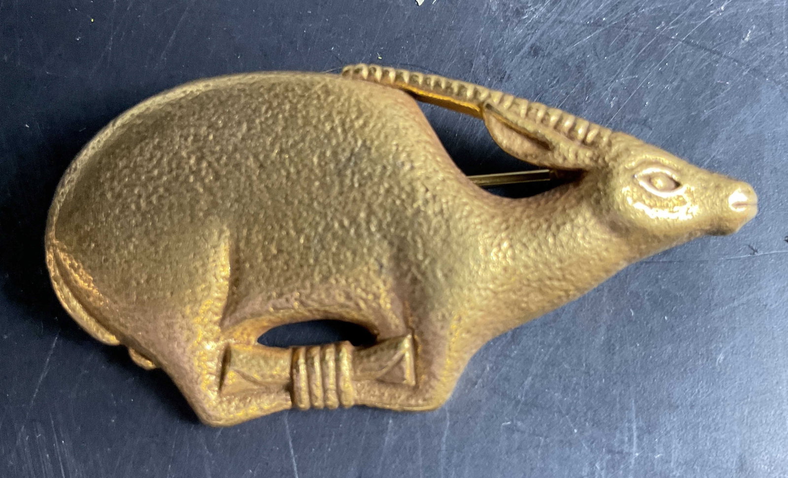 MMA 24k Plated Bronze Oryx Pin: Vintage estate jewelry, MMA Oryx Pin crafted from bronze with a rich 24k gold plated finish, featuring a textured design inspired by Egyptian Art, capturing the graceful form of an Ibex, Oryx, with a 