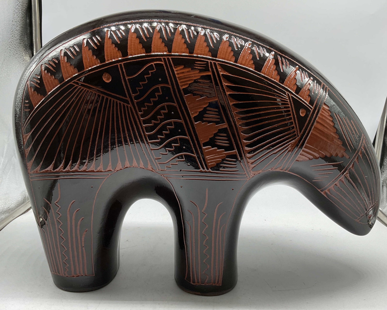 Hand Crafted Native American Bear Sculpture, Sgn: Signed on underside, Native American Hand crafted Pottery Bear features a glossy black finish with intricate sgraffito etched geometric and wild life designs in reddish brown tones, southwestern