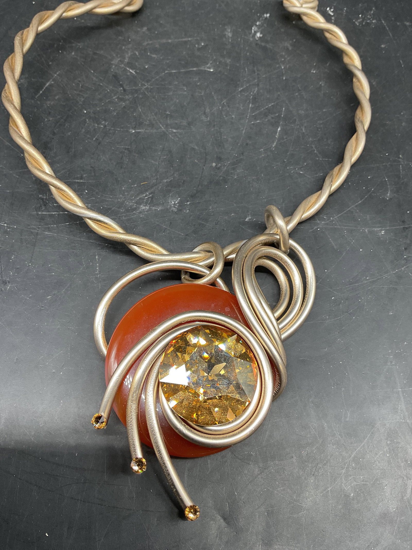 Jeff Lieb Art Piece Statement Necklace USA: Signed with plaque Jeff Lieb, American modernist jewelry designer based in Chicago, USA, piece features a vibrant red carnelian agate stone donut wrapped in thick hand formed metallic wire, as is his