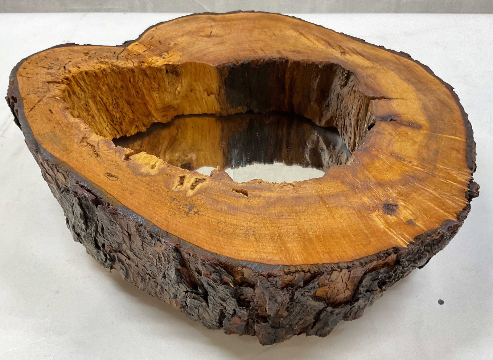Rustic Hollow Log Live Edge Mirror: Rustic live edge hollowed out log or tree trunk, bark remaining on exterior, which is styled as a natural wood framed live edge mirror, crafted from a natural tree trunk cross section featuring