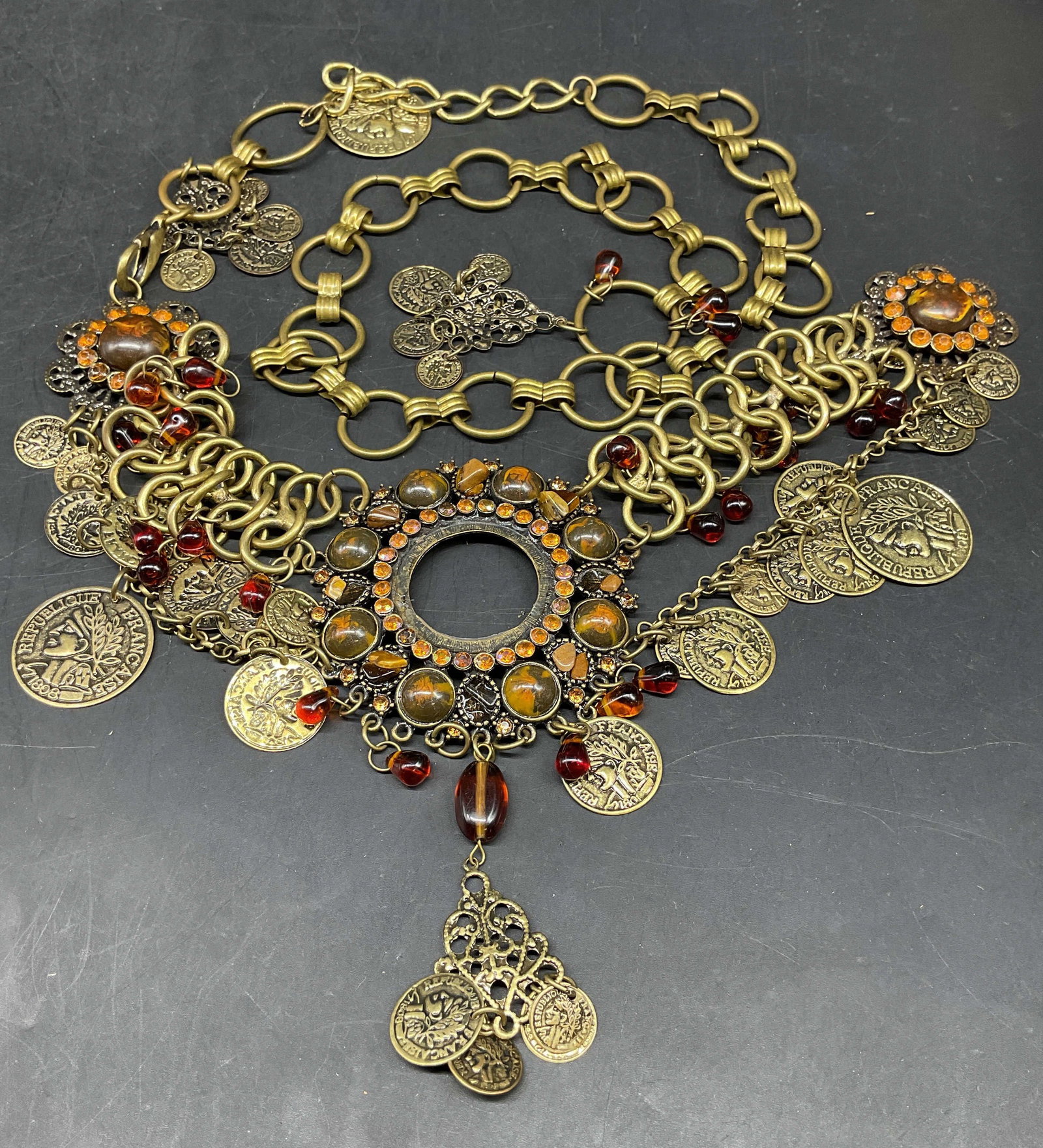 Ornate Coin Dangle Statement Necklace or Belt: Ornate antique style gold tone brass statement necklace Or belt, features intricate coin dangles, amber hued resin hued cabochon and a layered link chain construction, only one end has clasp, may need