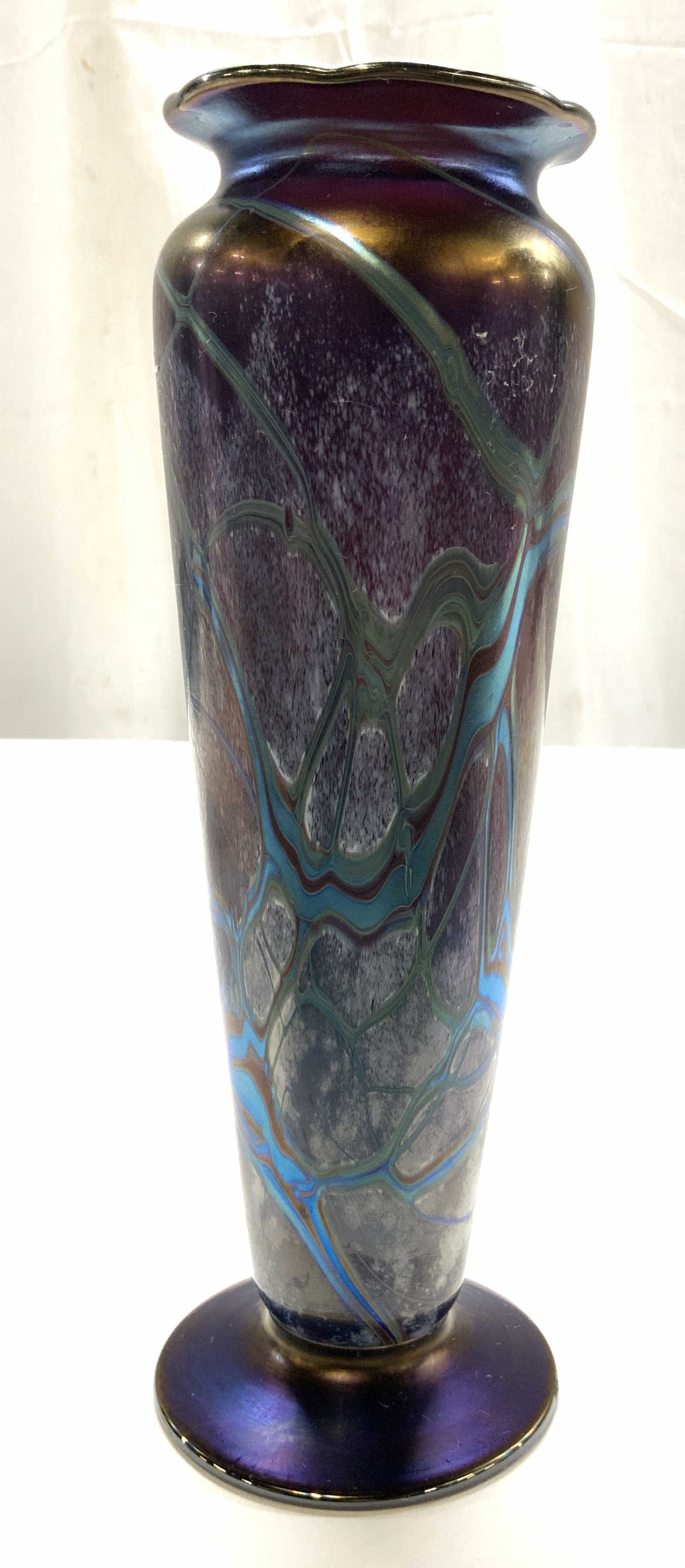 Signed Art Deco Iridescent Art Glass Vase: Signed and dated illegibly on underside, iridescent Art glass vase features a purple , and copper toned amber background with fluid pulled turquoise feather and vine motifs and ruffled rim, loetz insp
