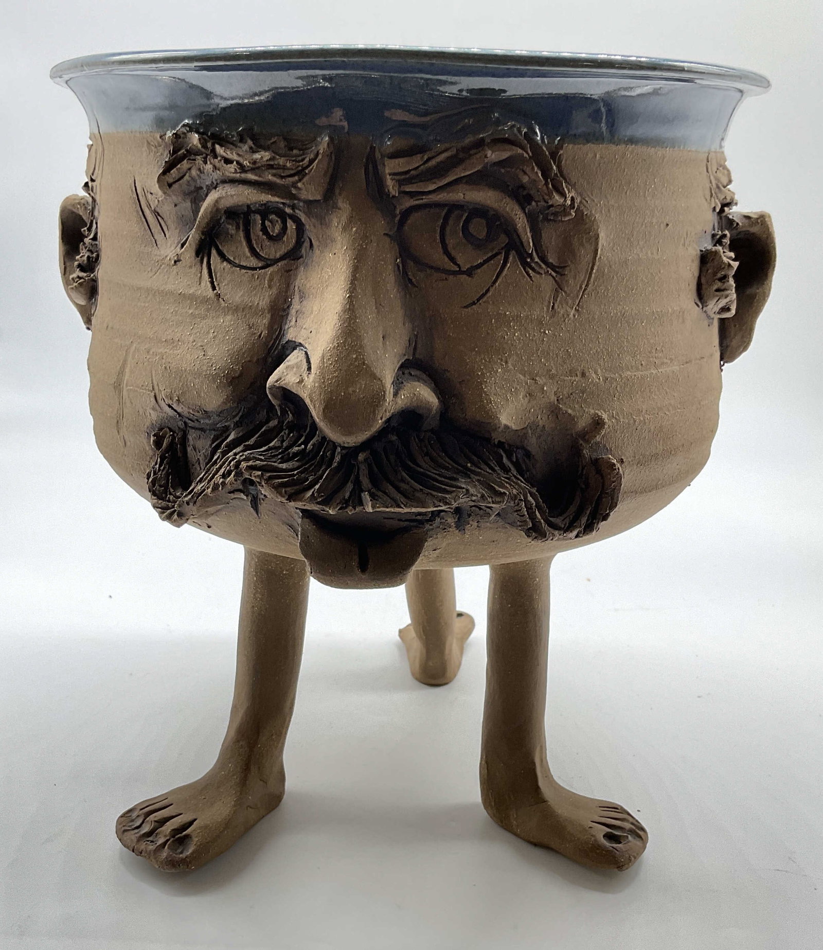 Handmade Ceramic Face and Feet Vessel, Sgn: Signed with initials on side, DLD, Folk art, hand made ceramic sculpture features an expressive human face with detailed facial features like a prominent nose and ears, and detailed mustache, styled a