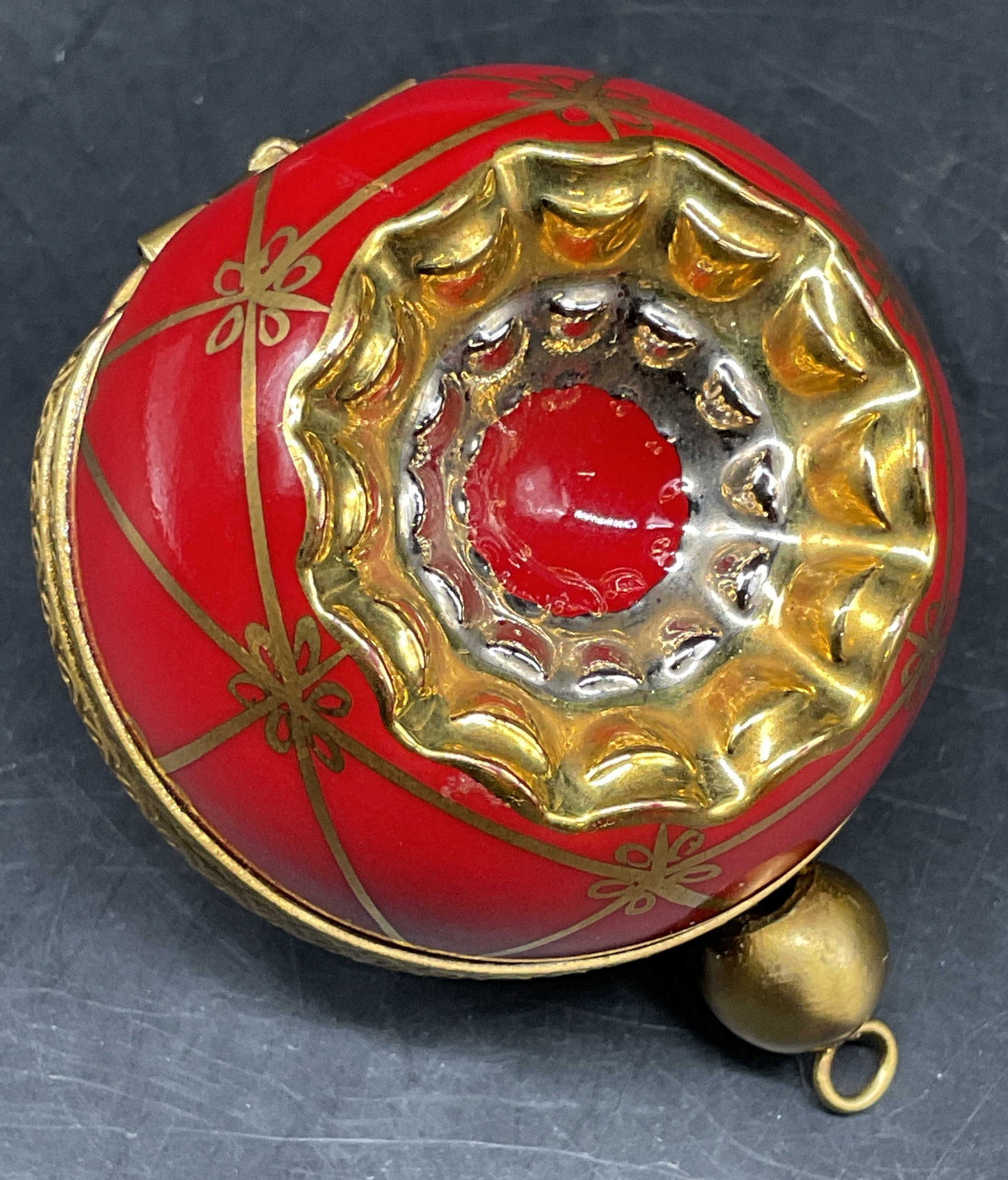 Limoges France Holiday Ornament Pill Box: Hinged lidded pill box, bright red gold accents, with center of gold, silver, red, concentric circle decor, , inside reads hand painted Limoges France, measures app 2 inches by 1.5 inches, Christmas o