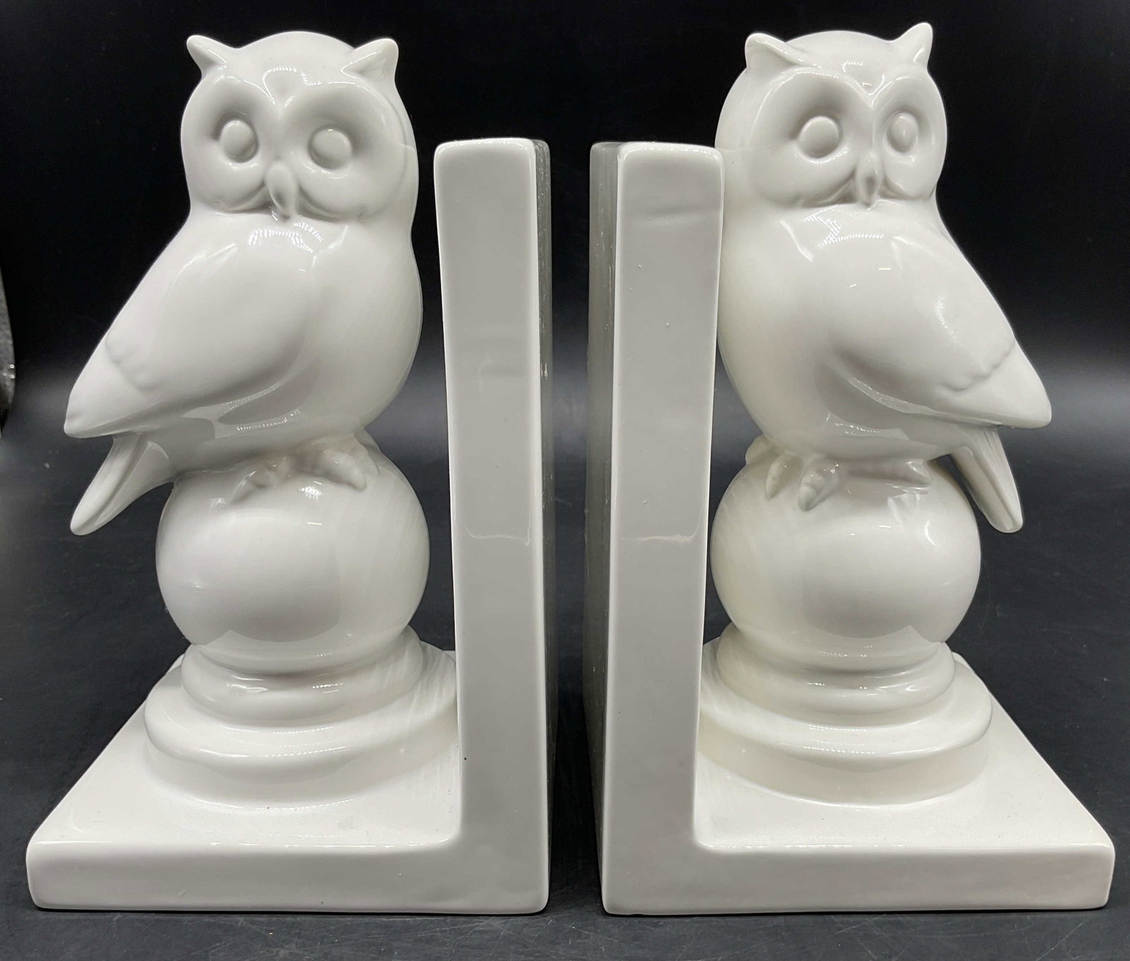 Glossy White Ceramic Owl Bookends: Glossy white ceramic owl bookends, featuring charming sculpted owls perched atop ball pedestals, each measures ht app 8 inches, by 4.5 inches square base