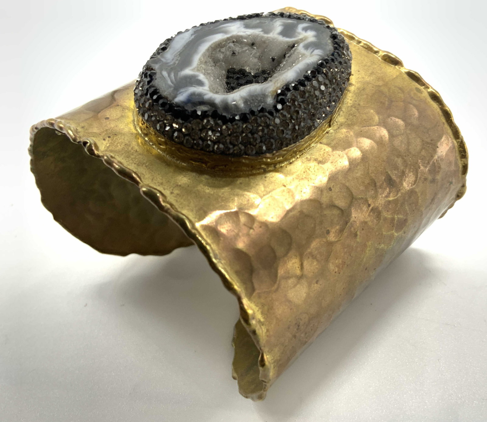 Felix Zuniga Geode Ctr Gold Tn Cuff Bracelet: Label on inside of bracelet, Felix Zuniga designed, statement cuff bracelet hand crafted hand hammered gold tone cuff features a prominent black and white Oct Geode slice centered with sparkling