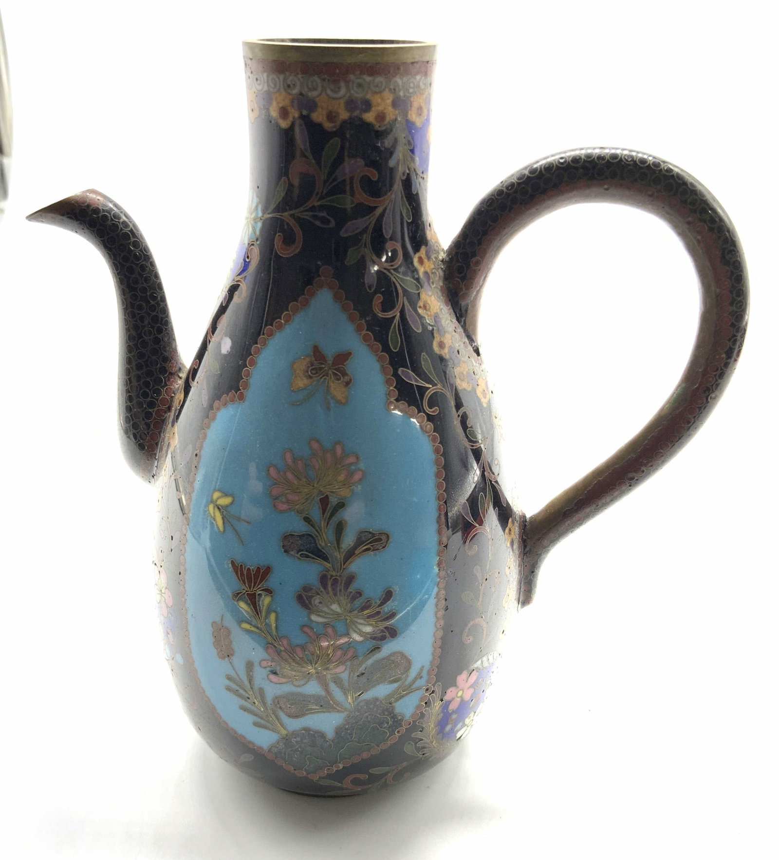Antq Asian Cloisonne Enamel Ewer: Antique possibly vintage cloisonne enamel Ewer, pitcher, featuring a dark ground and prominent light blue teardrop reserve panel and butterfly motifs, measures ht app 6 inches, handle to spout app