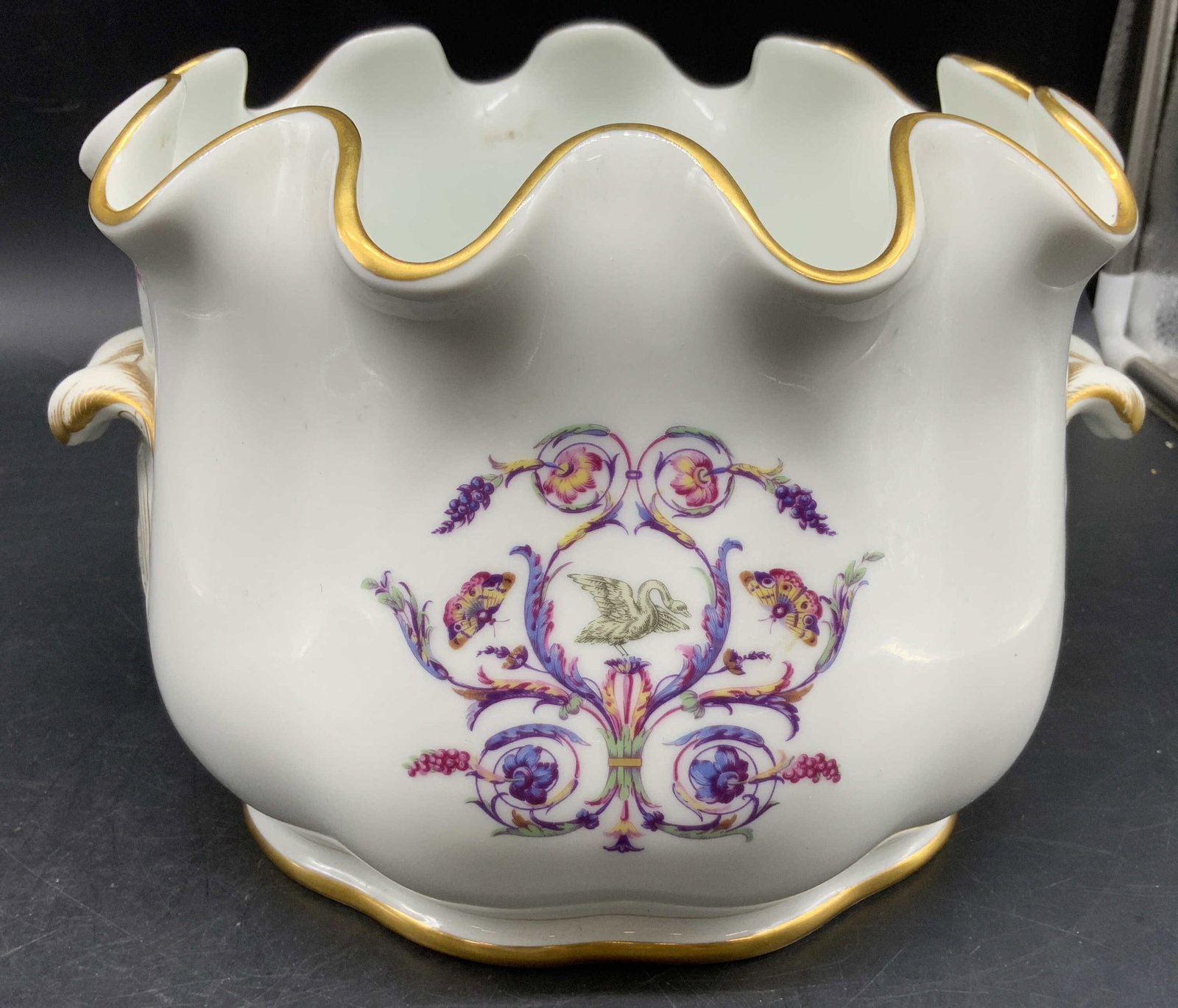 Richard Ginori Monteith Porcelain Bowl, Italy: Richard Ginori Monteith bowl in the discontinued Rapallo Pattern , featuring a scalloped gold trimmed rim and delicate polychrome floral and ribbon motifs with a central swan, measures ht app 6.5 inch