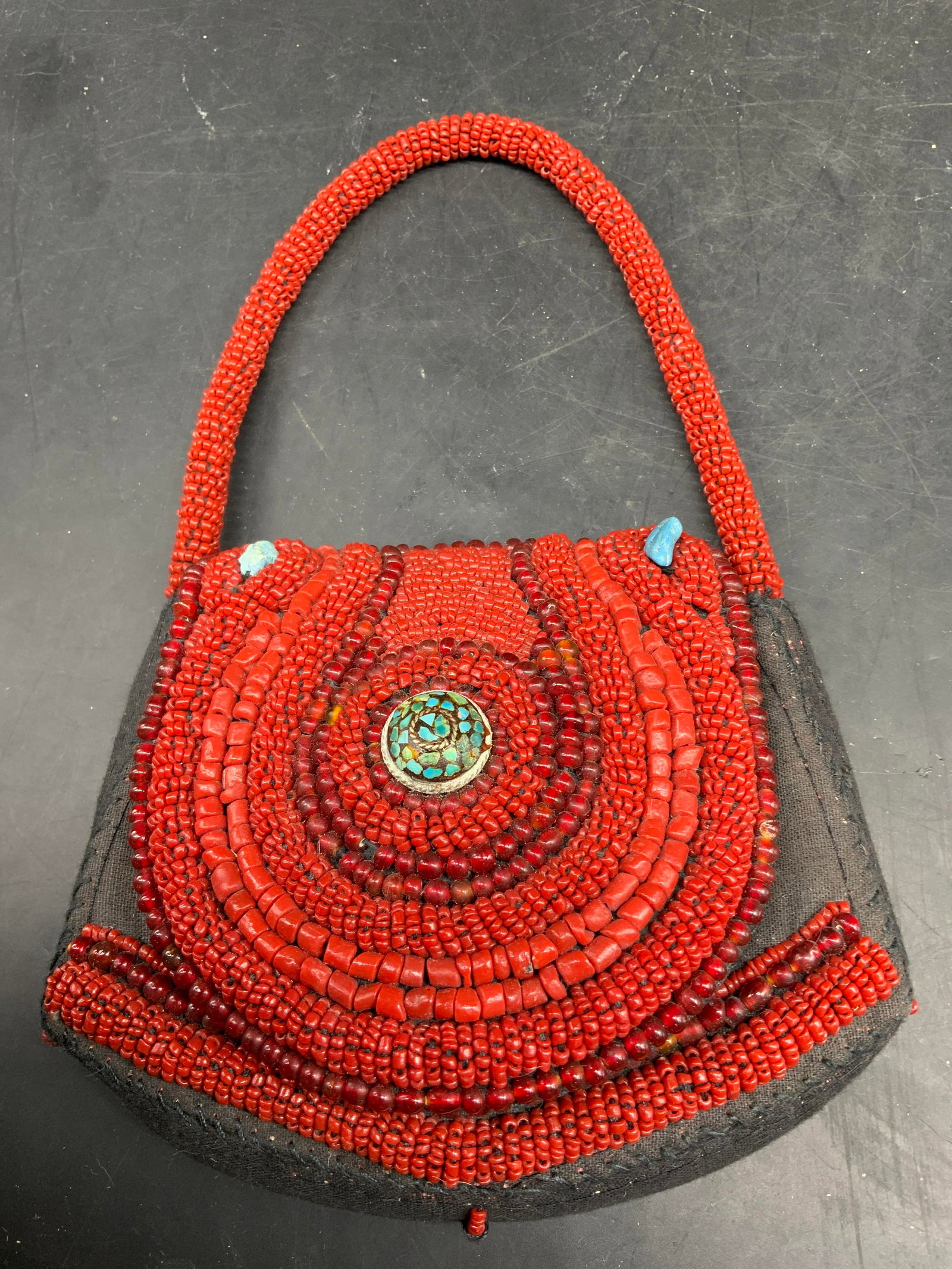 Vntg Sudha hand beaded Red Coral Turquoise Bag: Label inside for Sudha, this vintage Sudha Hand Beaded red coral and turquoise evening bag features concentric circular beadwork and a central cabochon stone mosaic turquoise, circa 1960. Bag measures
