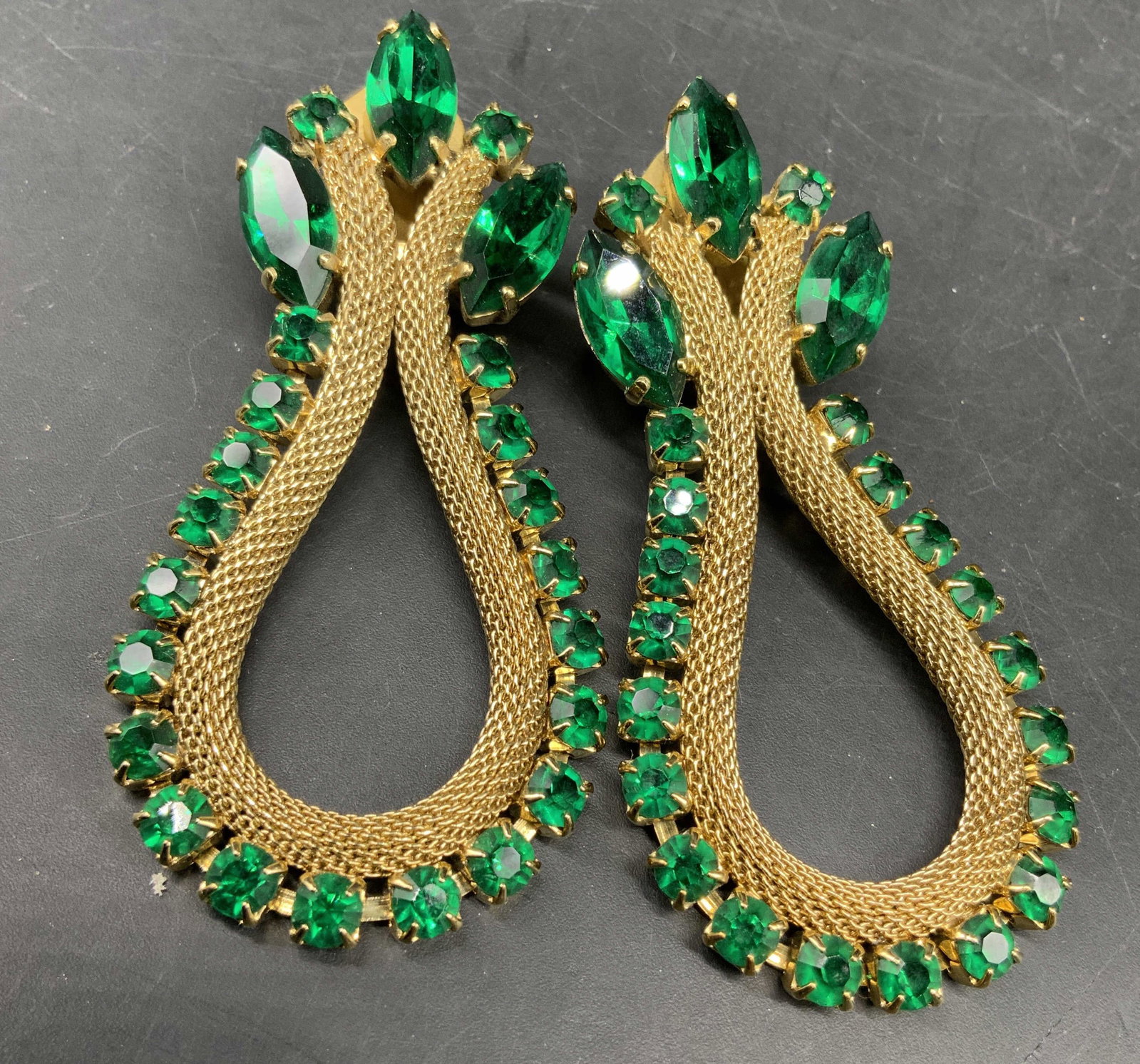 Vntg Gold Tn Rhinestone Drop Statement Earrings: Vintage gold tone Statement earrings featuring vibrant green rhinestone crystals in marquise and round cuts, designed with a textured mesh tear drop loop, drop length app 2.75 inches, estate jewelry